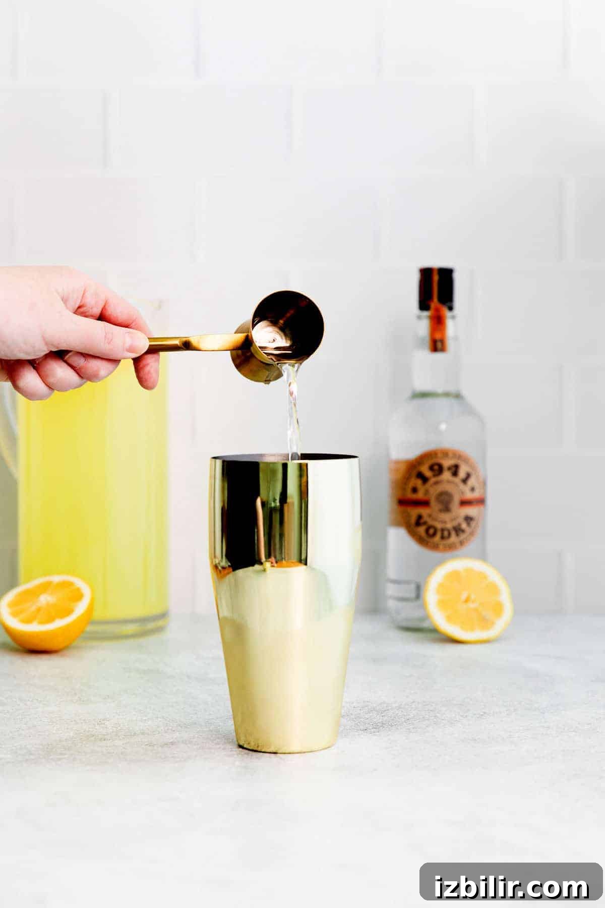 adding vodka into cocktail shaker adding vodka into cocktail shaker