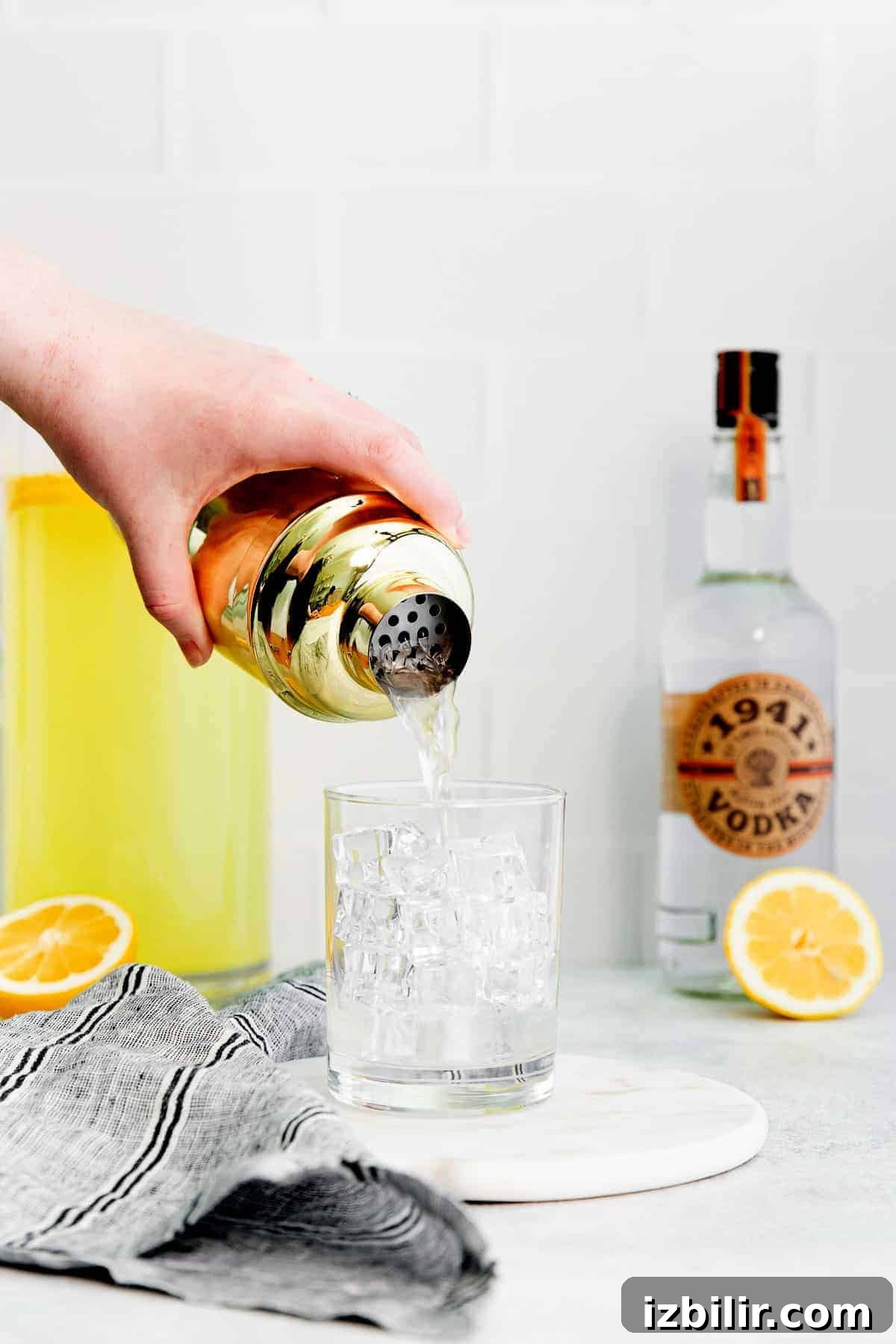 pouring vodka lemonade into glass pouring vodka lemonade into glass