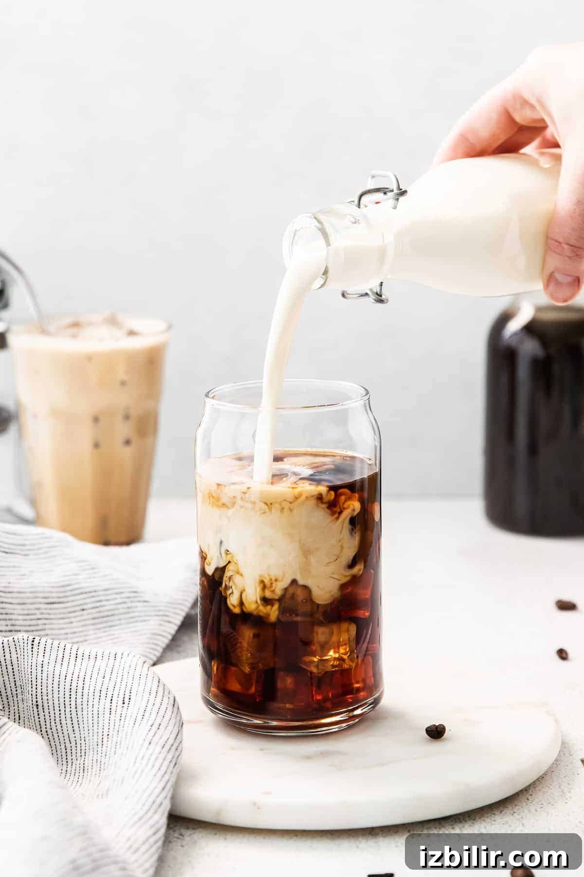 Pouring sweet cream into cold brew.