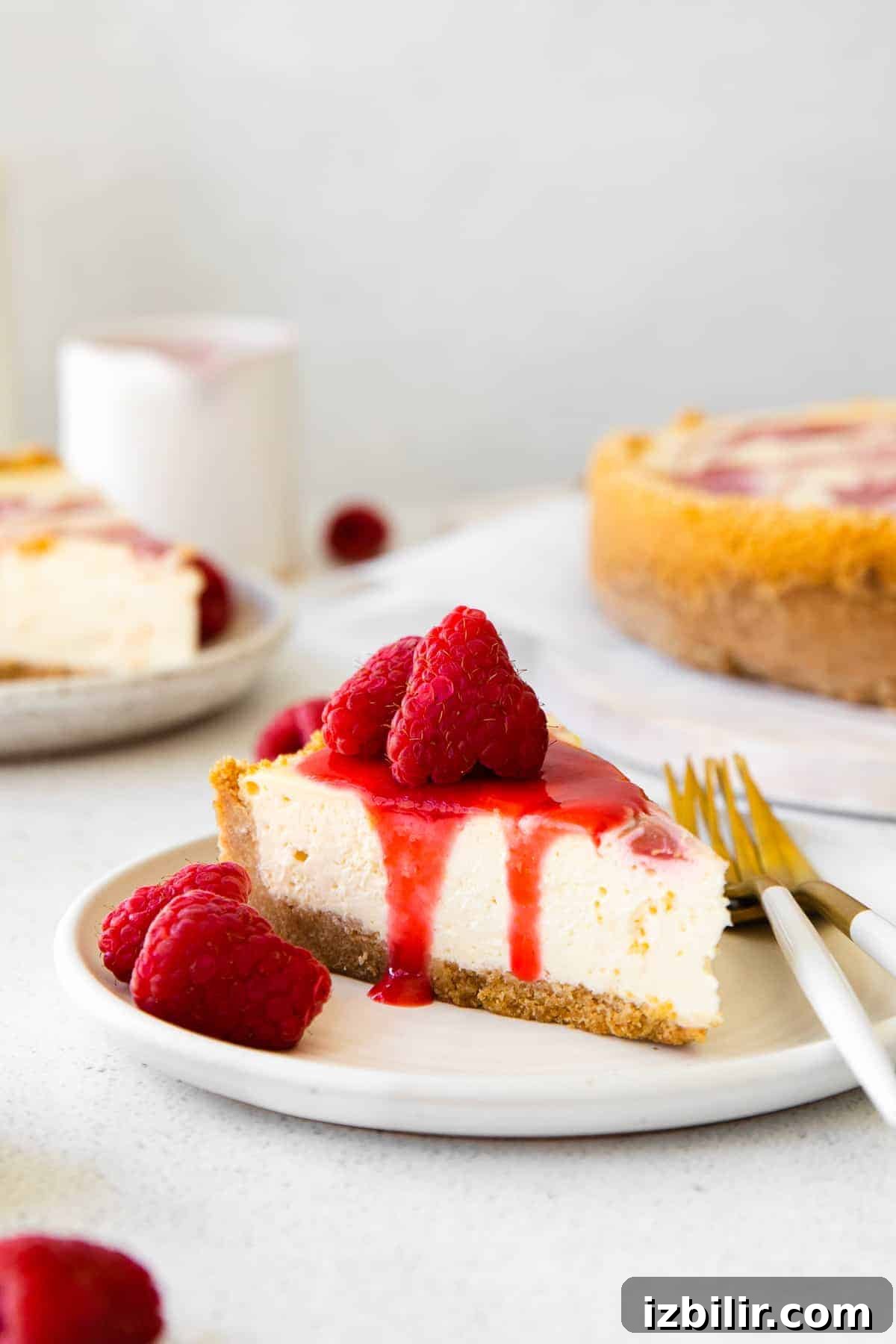 Cheesecake slice with raspberries a slice of healthy cheesecake topped with raspberry swirl and additional fresh raspberries