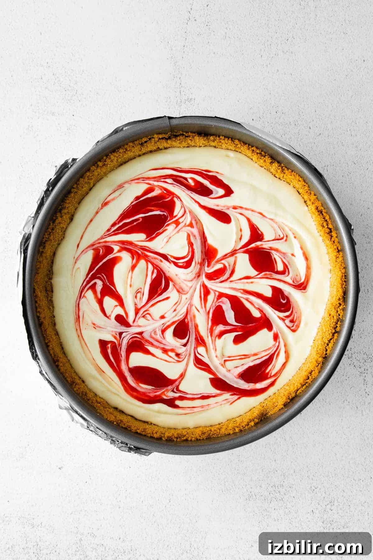 Greek Yogurt Cheesecake with raspberry swirl greek yogurt cheesecake topped with raspberry swirl