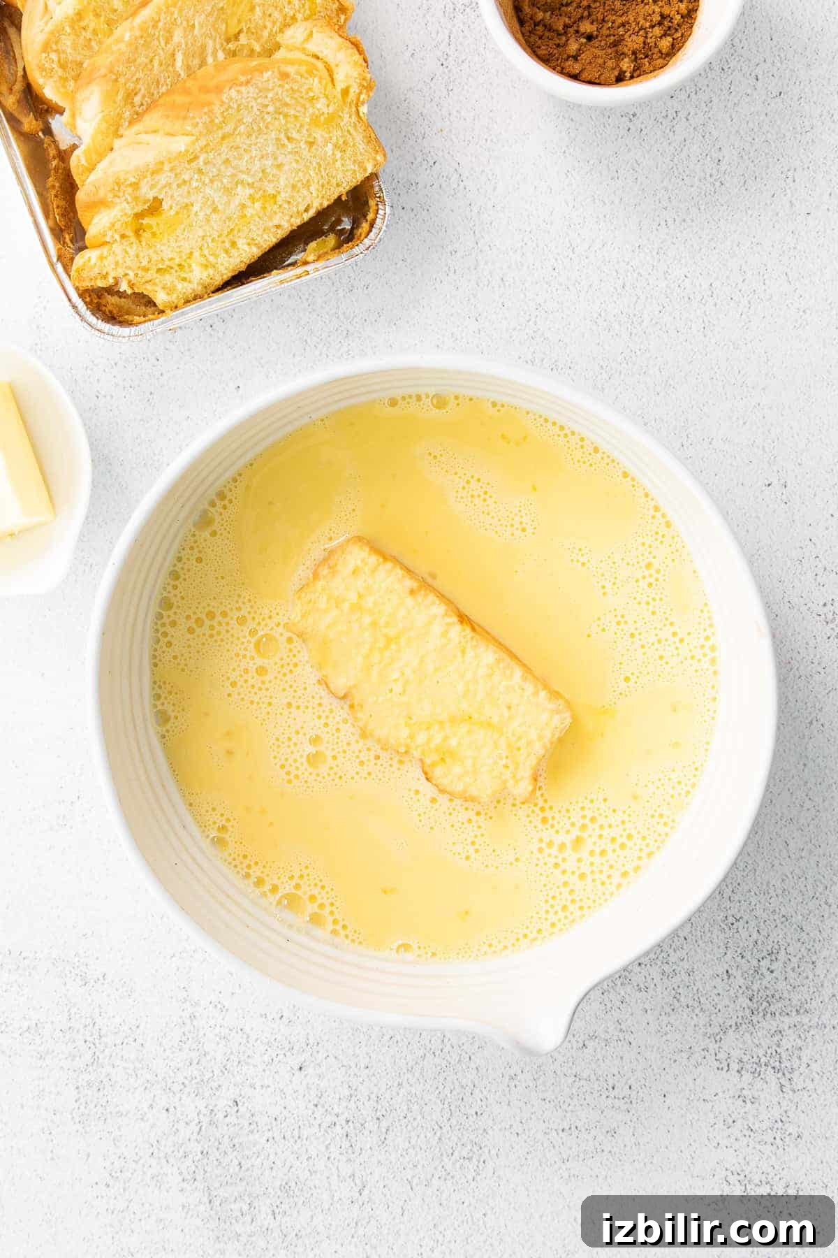 slice of bread in an egg wash for french toast