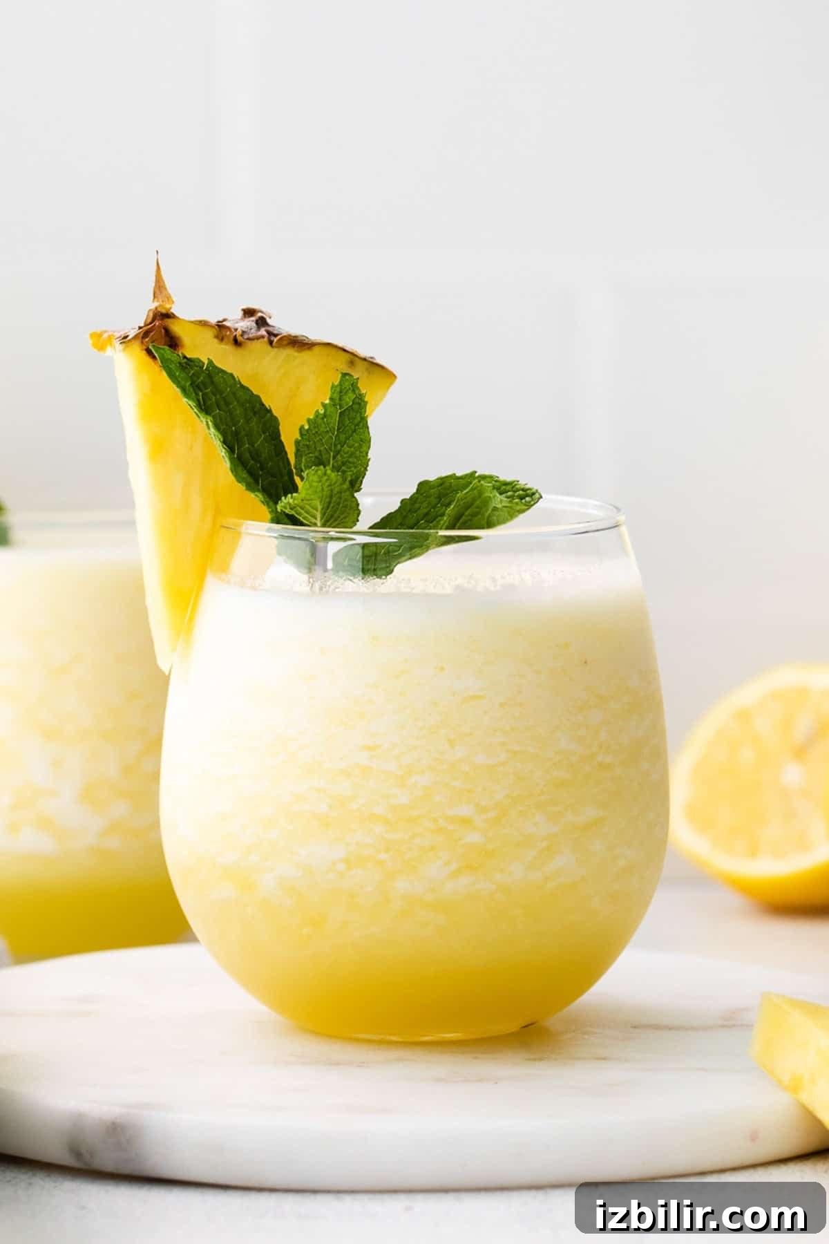3 Wine Slushie Recipes for Summer Sipping 4 a glass of lemonade with a pineapple garnish.