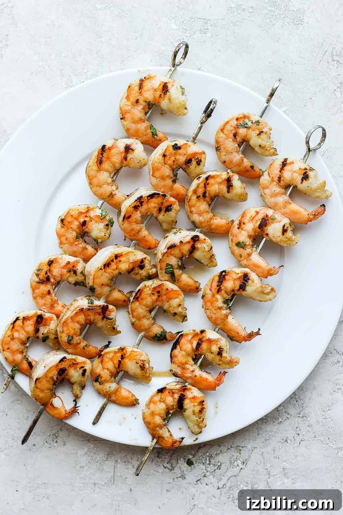 Grilled shrimp served on a plate Grilled shrimp on skewers on a plate.