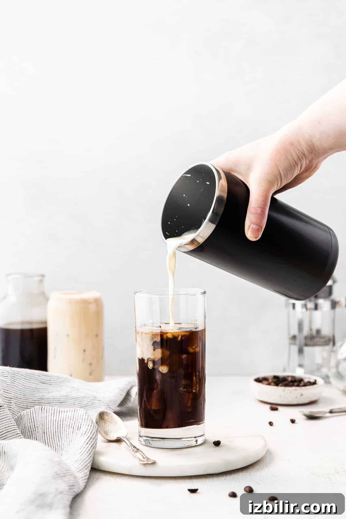 Pouring sweet cream cold foam into a cup