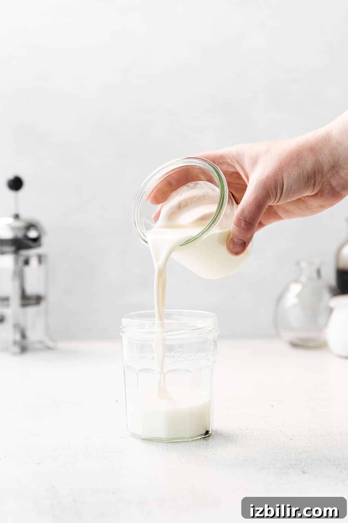Pouring vanilla sweet cream into jar