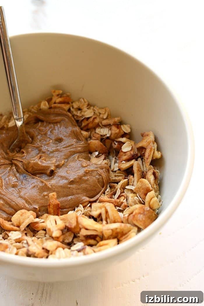 These Apple Chai Energy Balls are made with rolled oats, dried apples, chai spices, and an almond butter base for a healthy fall sweet treat. Great for snacks on the go! apple chai energy balls ingredients in a bowl