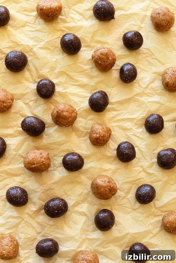 Peanut Butter and Jelly Swirl Energy Balls 2 No-bake peanut butter and jelly inspired energy balls on a plate.