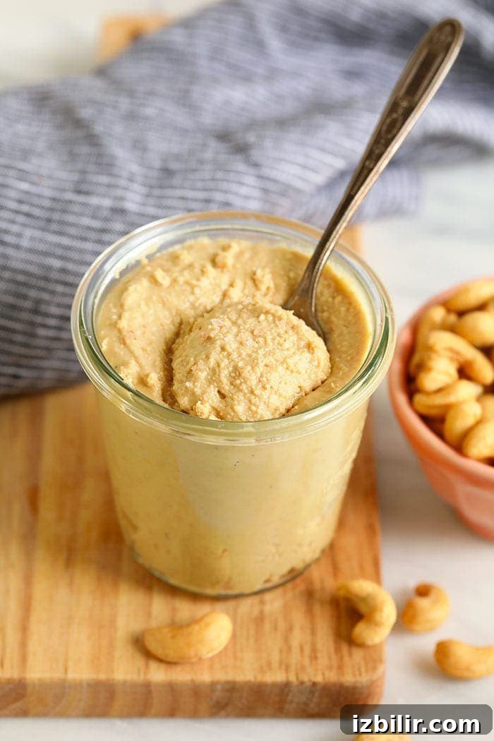 Make your own cashew butter with just a few simple ingredients cashew butter in a glass jar with a spoon