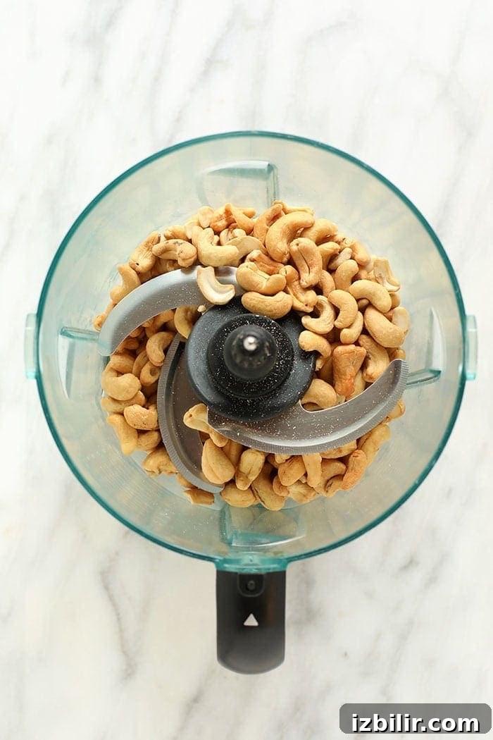 Cashews in food processor ready to become cashew butter cashews in a food processor