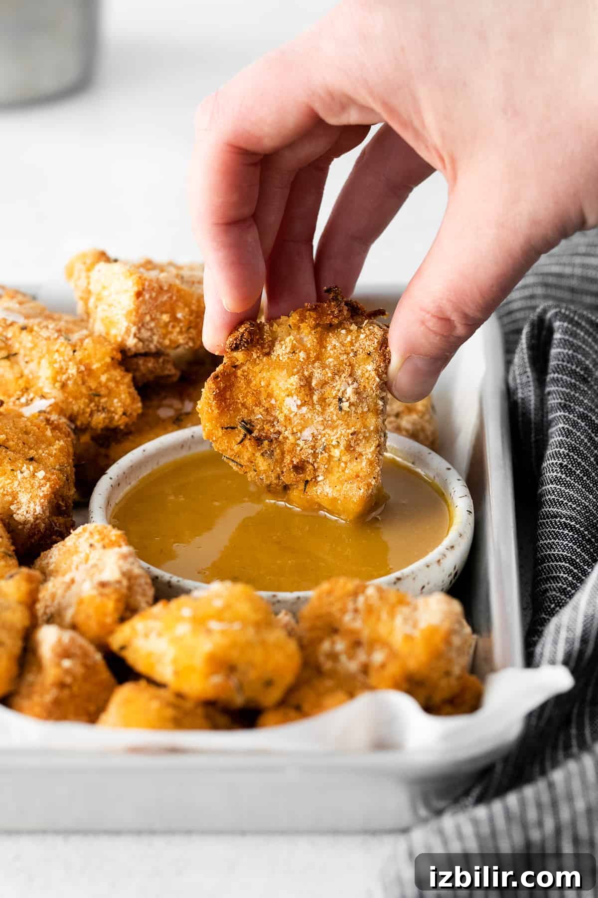dipping chicken nuggets in honey mustard