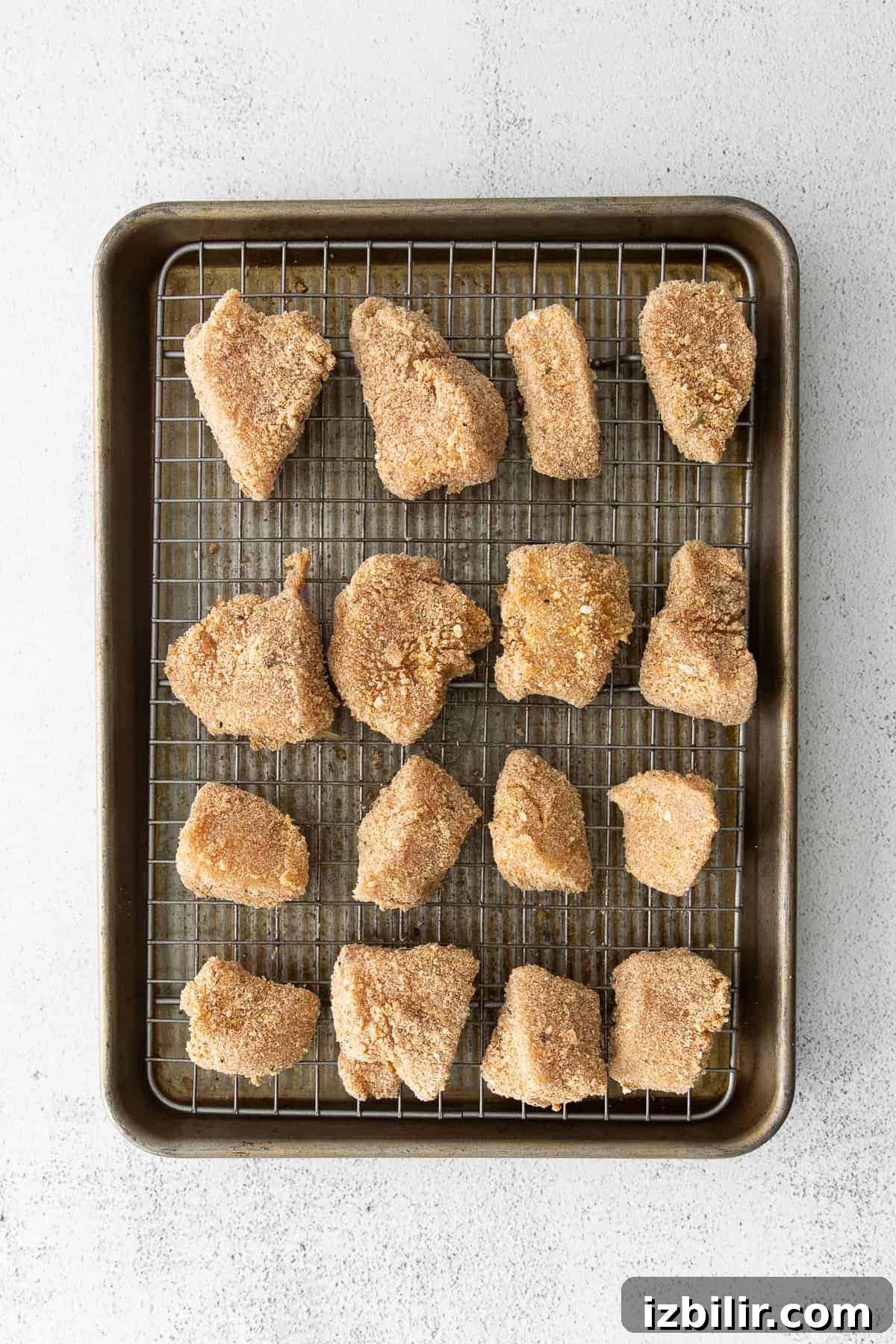uncooked chicken nuggets on baking sheet