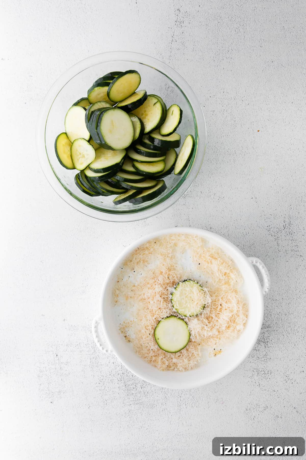 sliced zucchini dipped into parmesan coating before being placed in the air fryer.