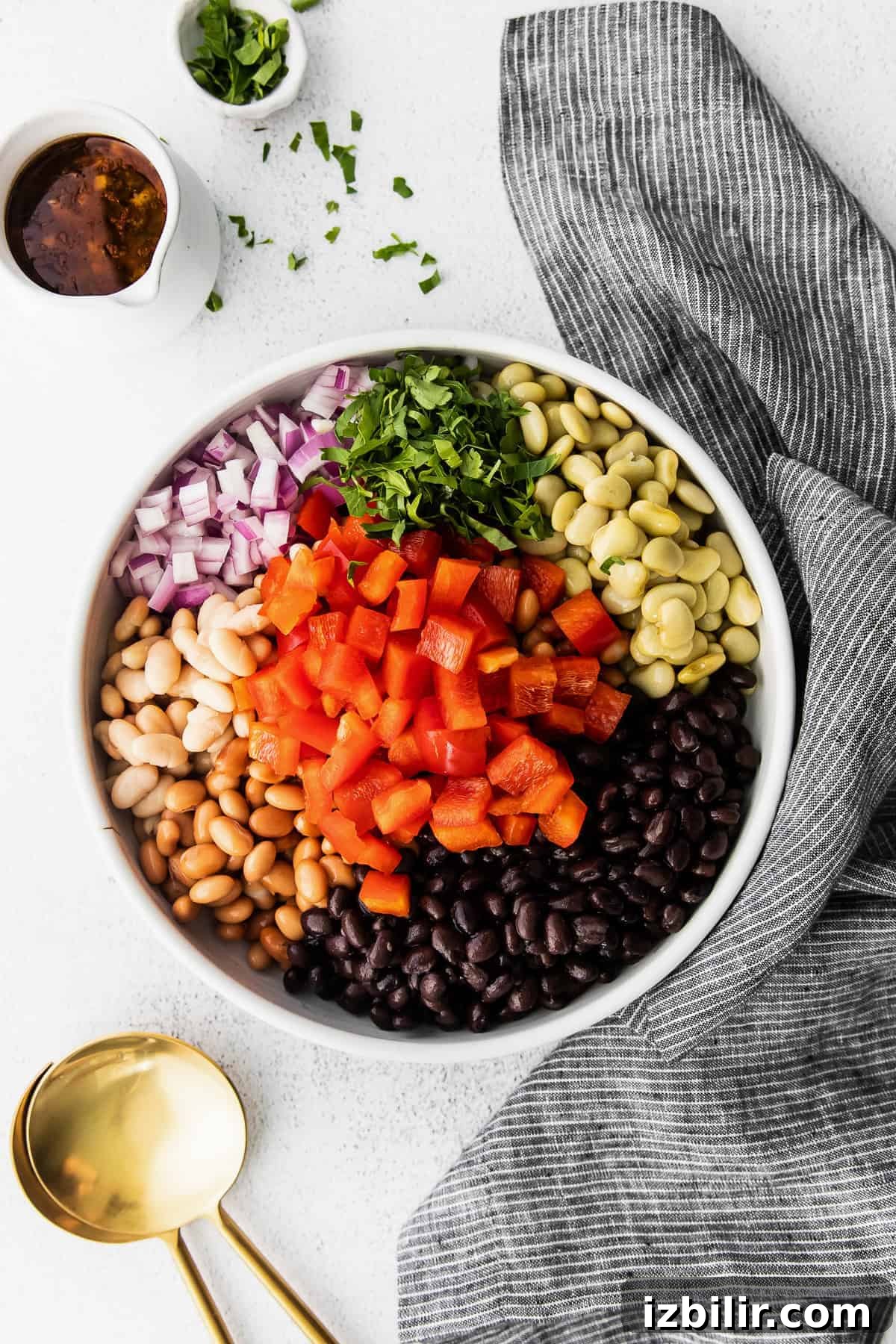 All the ingredients for bean salad in a bowl.