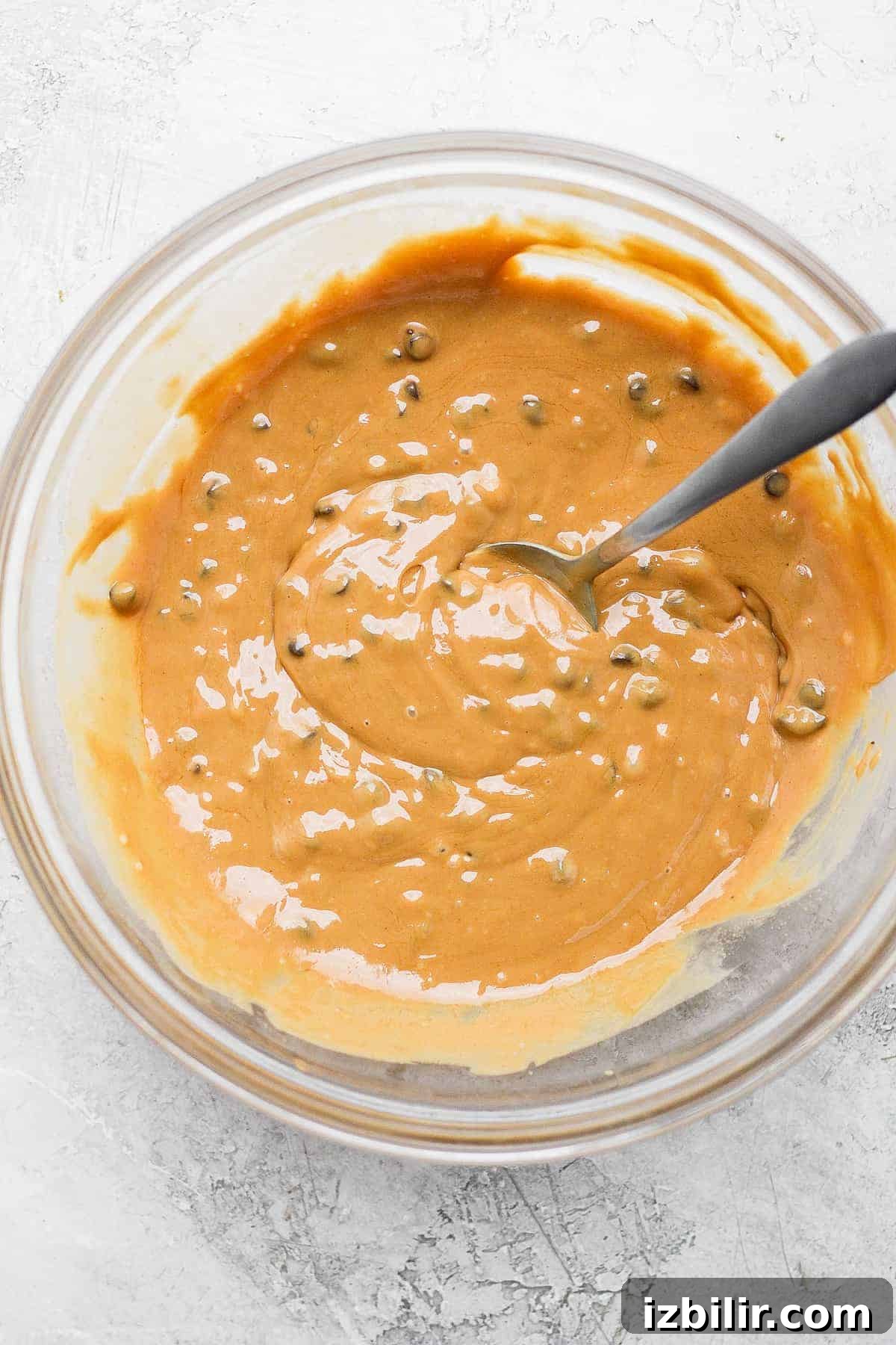 Mixing Cookie Dough Freezer Fudge Cookie dough freezer fudge ingredients mixed together in a bowl with a spoon