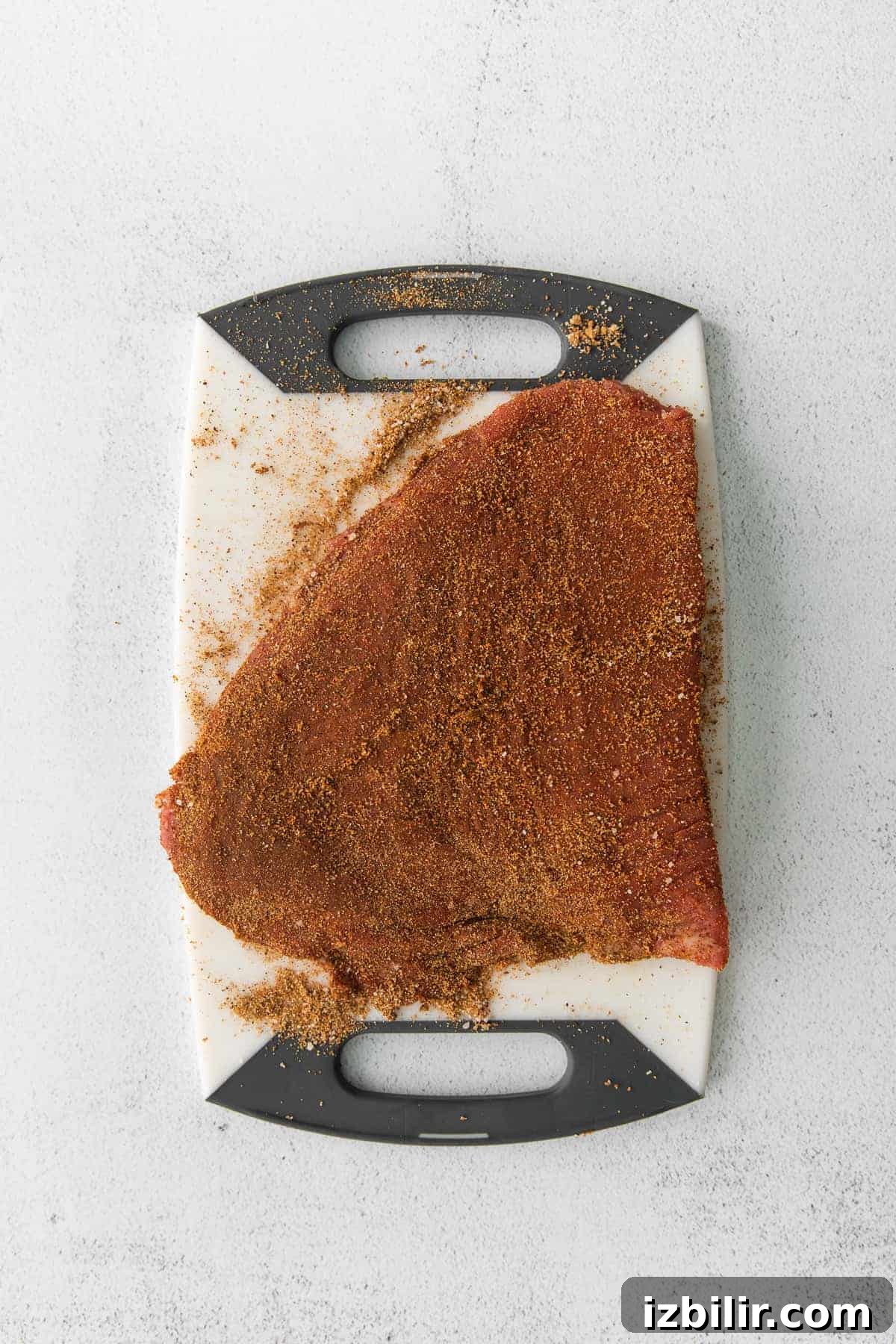 Flank steak with a dry rub flank steak with a dry rub on a cutting board