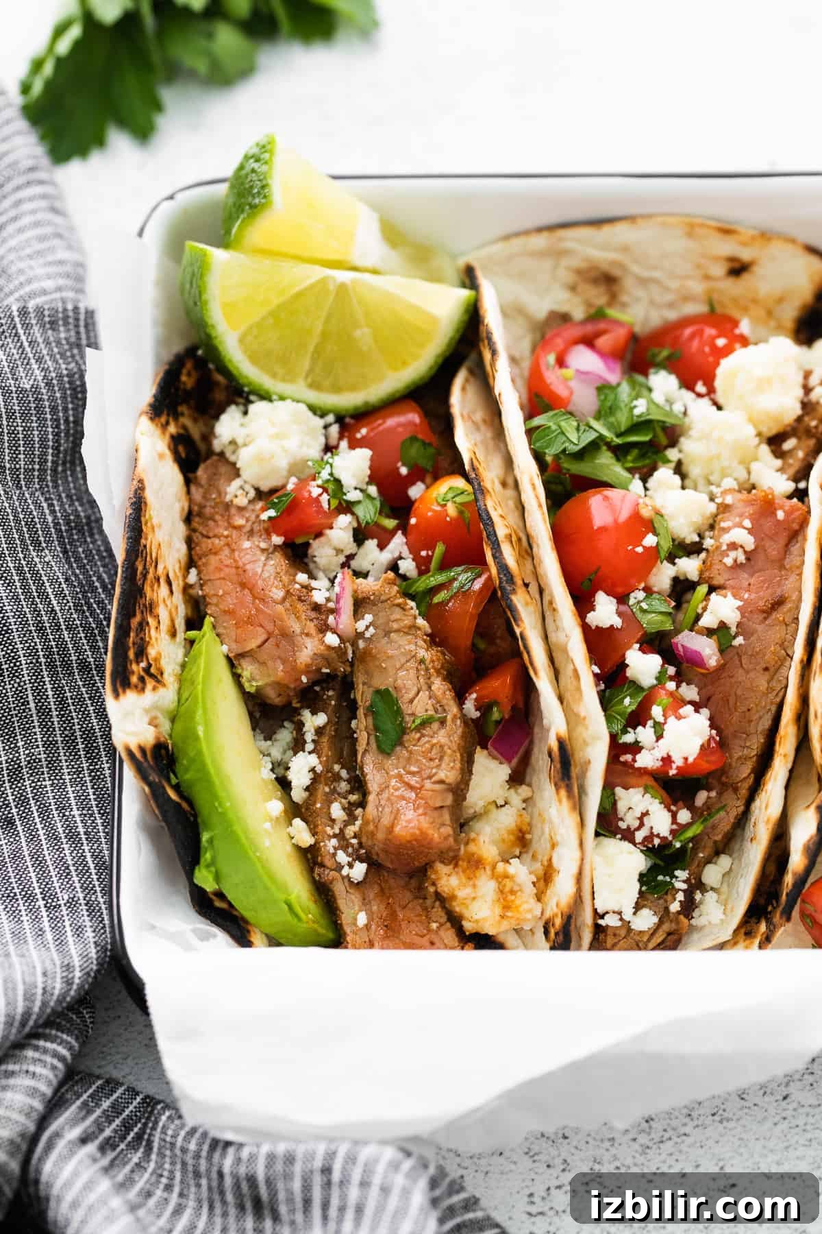 Close up of steak tacos with lime close up photo of steak tacos garnished with fresh lime slices