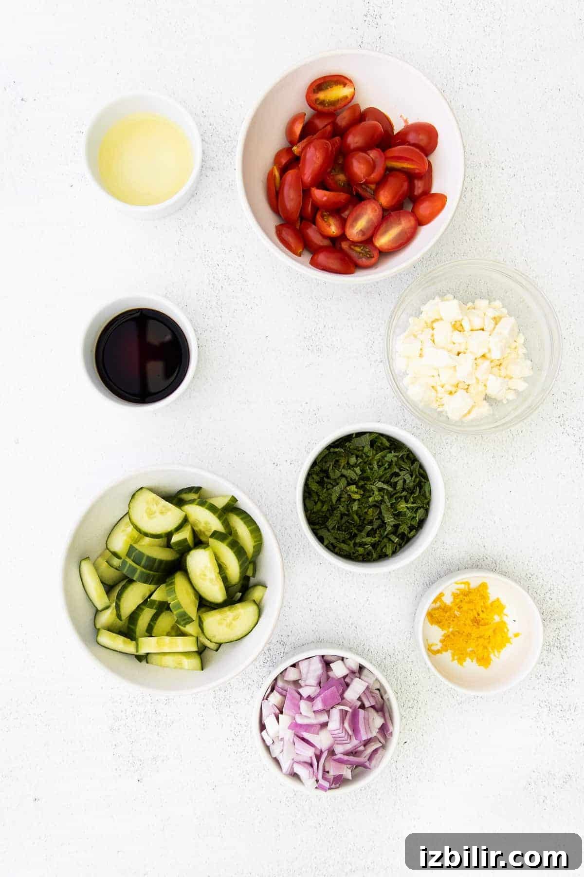 ingredients for mediterranean couscous salad in small bowls ready to be mixed together
