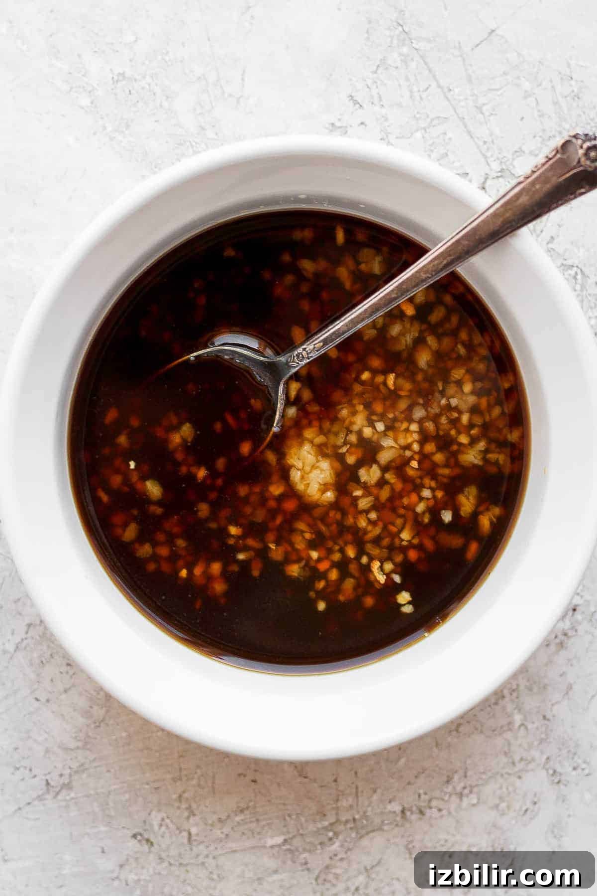Marinade in a bowl marinade in bowl with spoon.