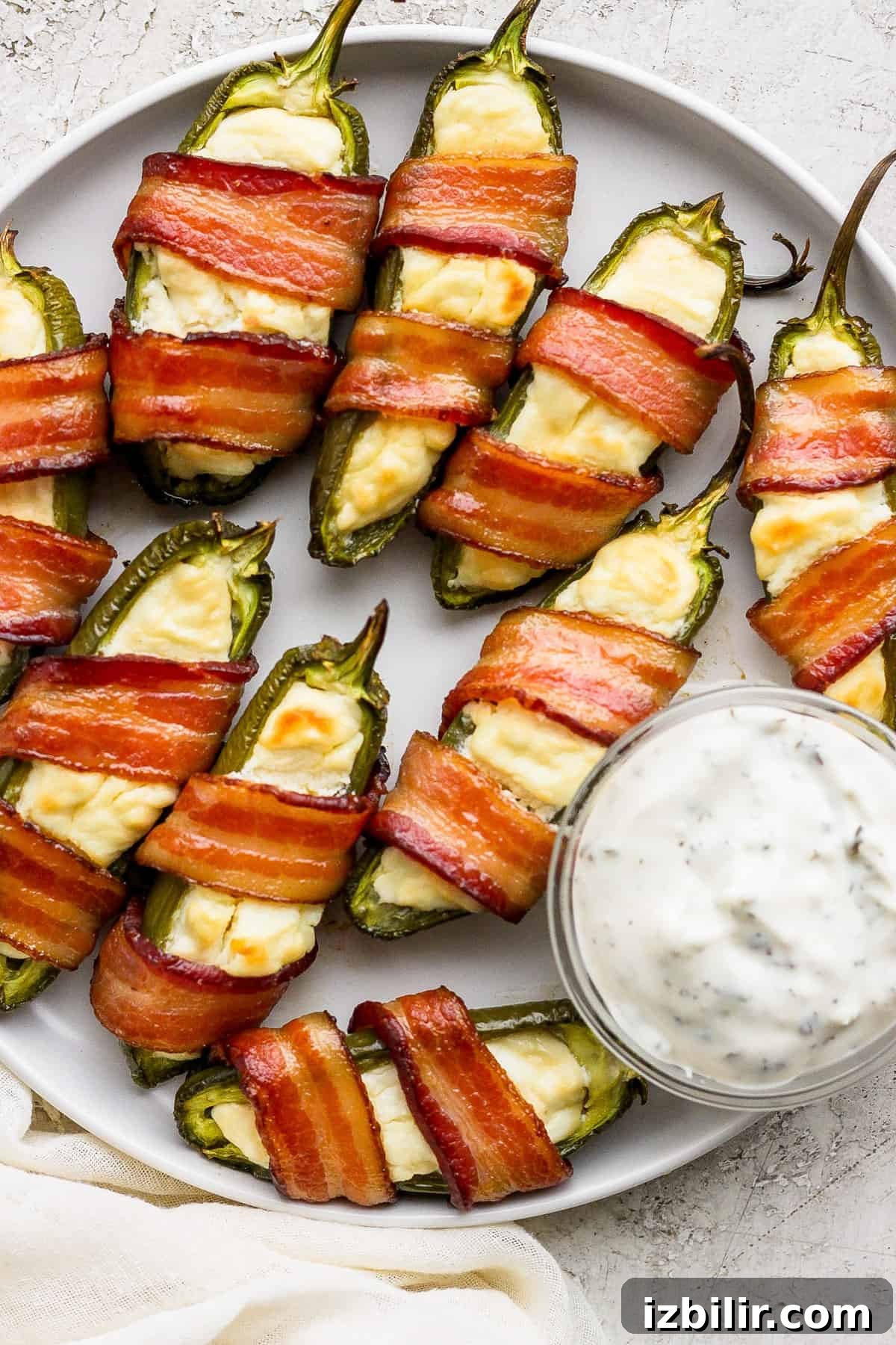 Bacon wrapped jalapenos on a plate.