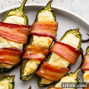Bacon wrapped jalapenos on a plate.