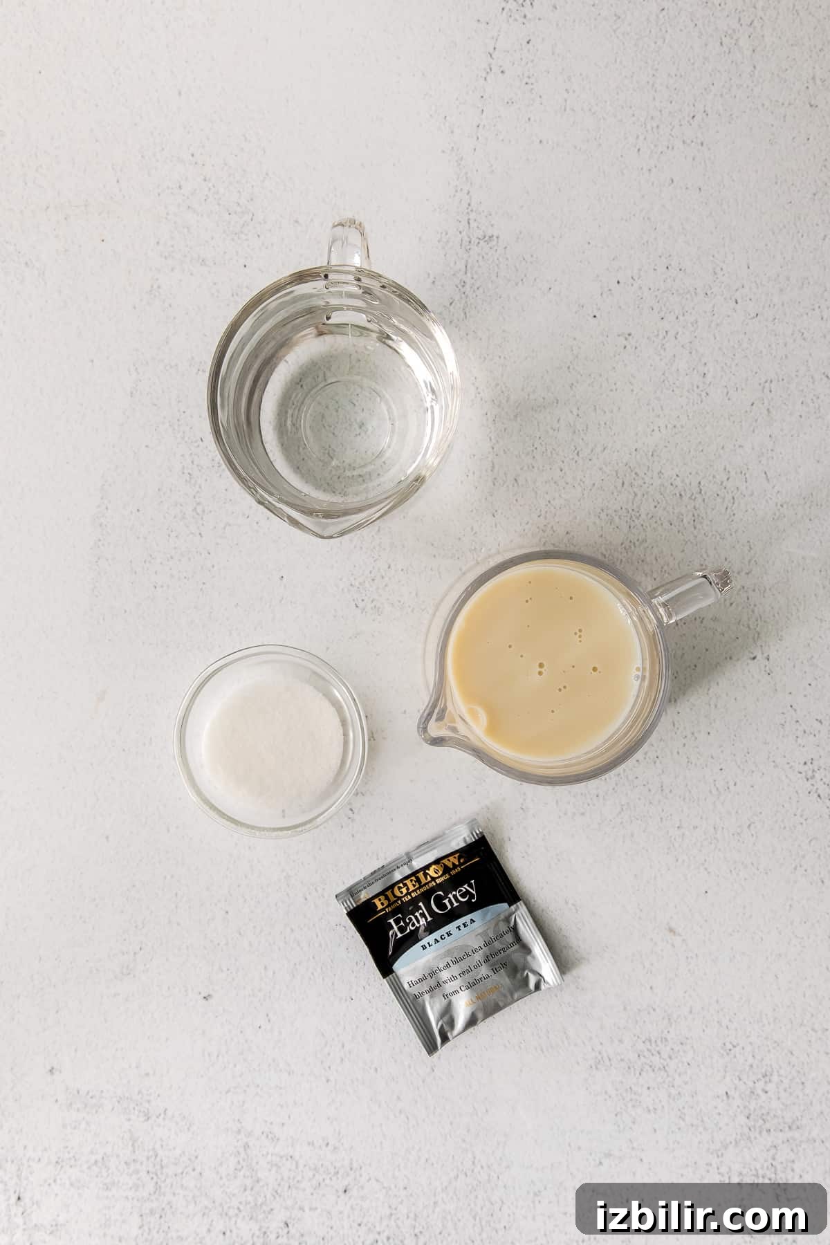 ingredients for a london fog drink in cups and mugs