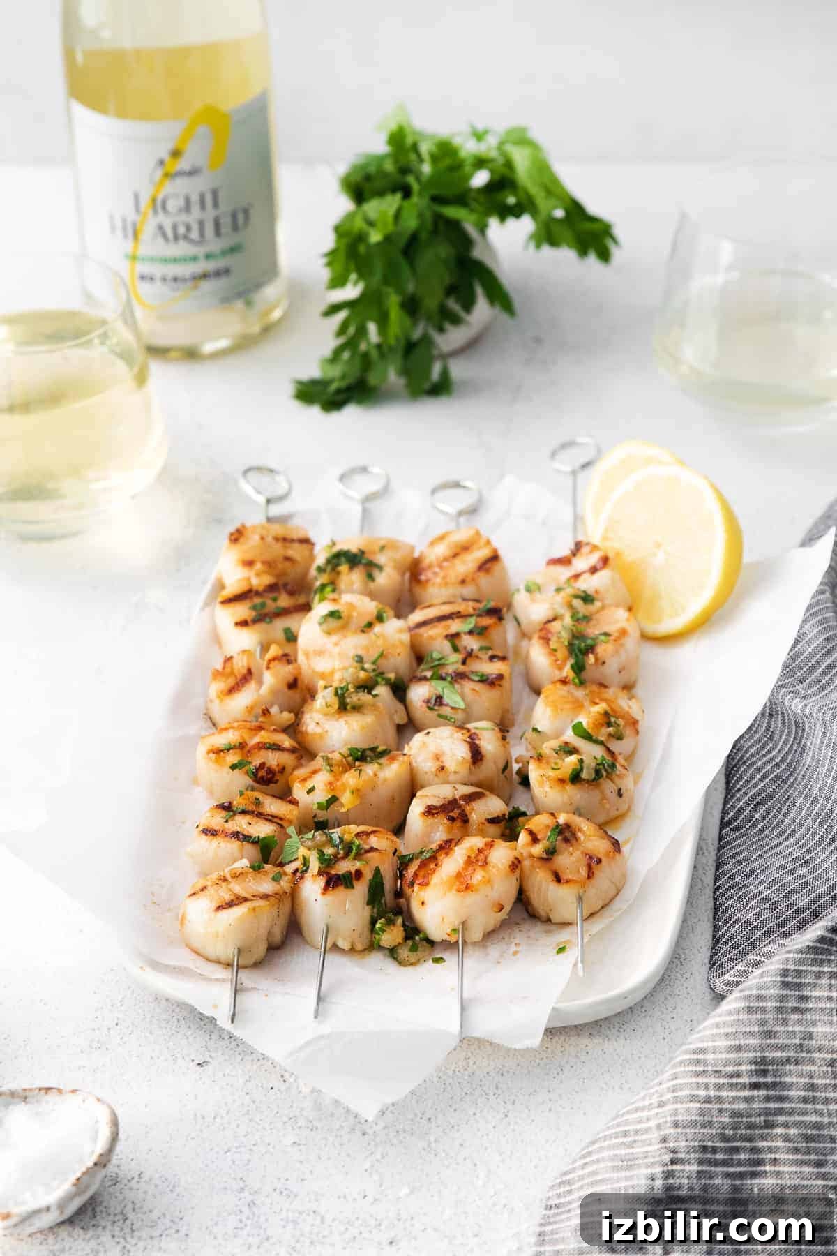 Grilled Scallops with Herbed White Wine Sauce 7 Scallops plated with herbs