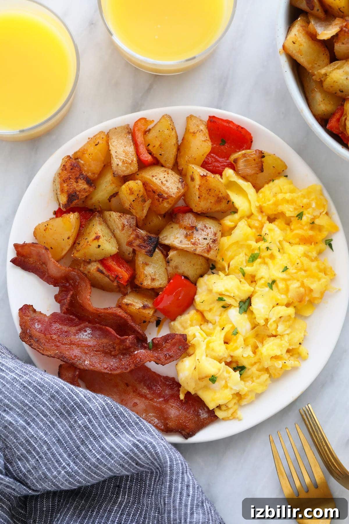 the best breakfast potatoes on a plate with eggs and bacon