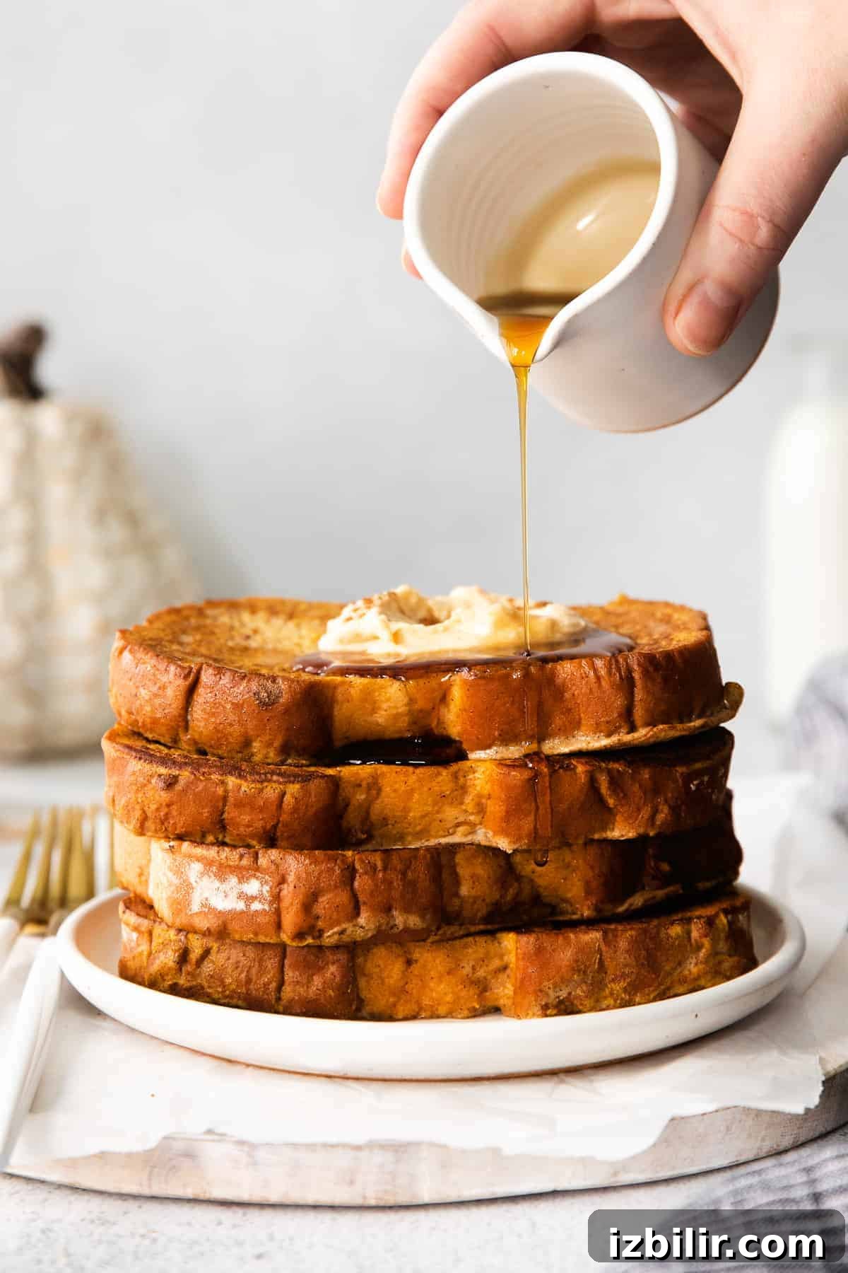 Fluffy Pumpkin French Toast Recipe with Maple Cinnamon Syrup 2 Pouring maple syrup over pumpkin french toast.