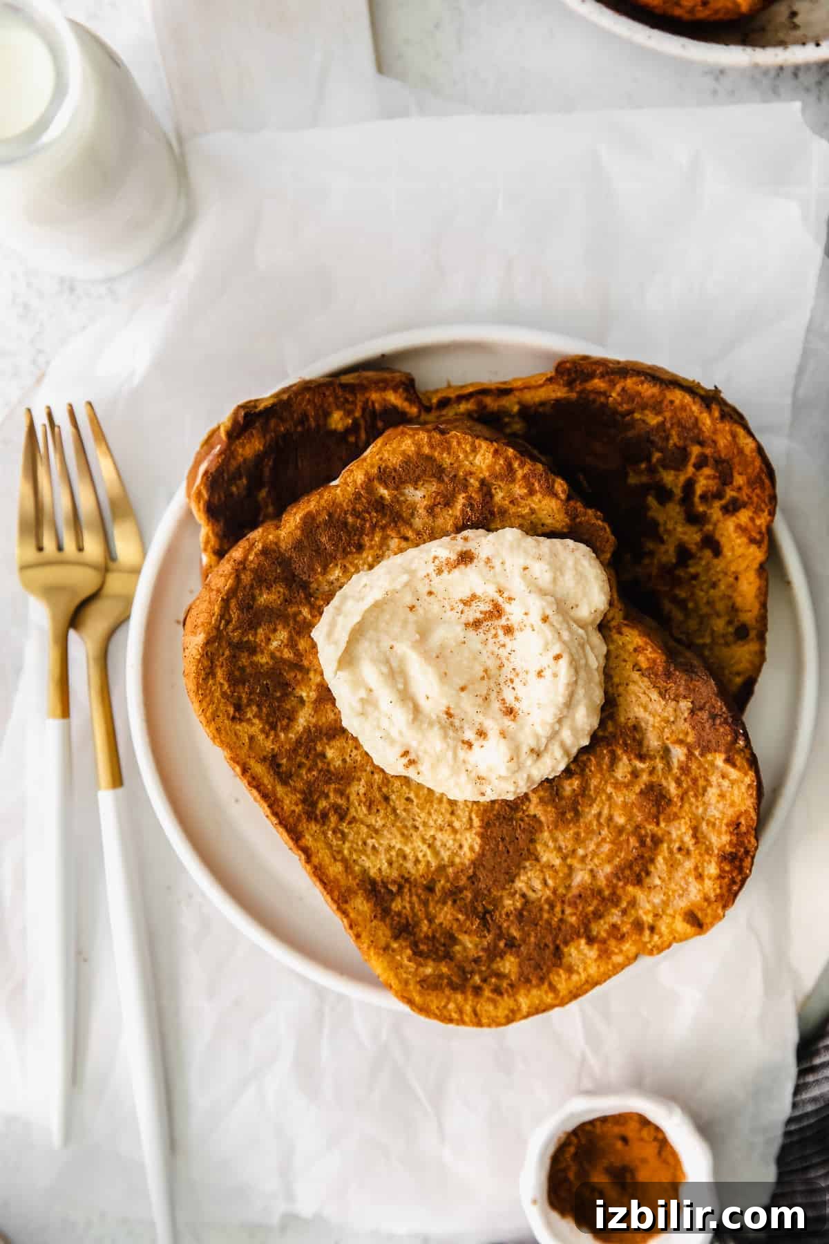 Fluffy Pumpkin French Toast Recipe with Maple Cinnamon Syrup 7 Pumpkin french toast topped with coconut whipped cream.