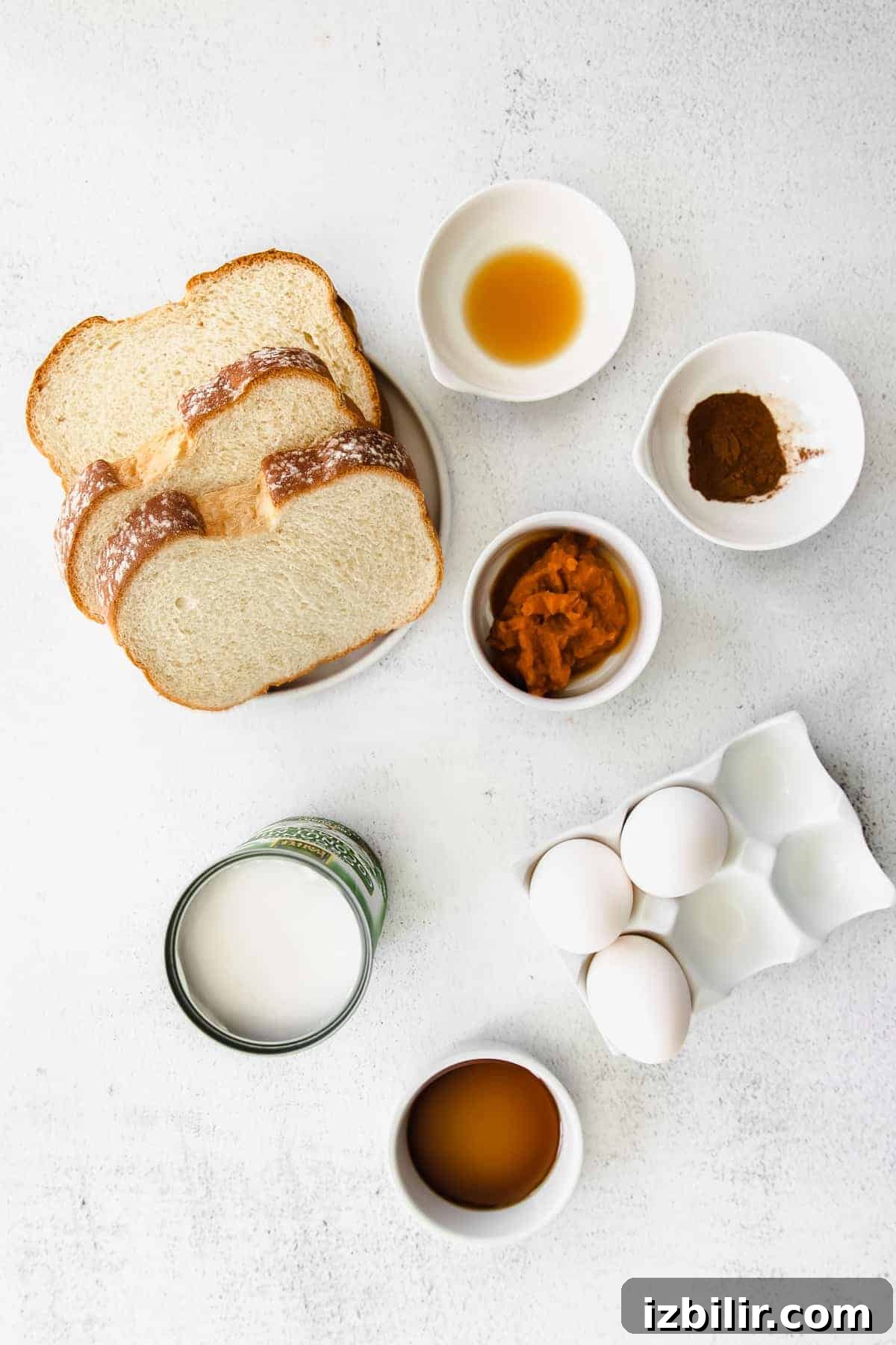 Fluffy Pumpkin French Toast Recipe with Maple Cinnamon Syrup 3 All the ingredients for pumpkin french toast in small bowls on the counter.