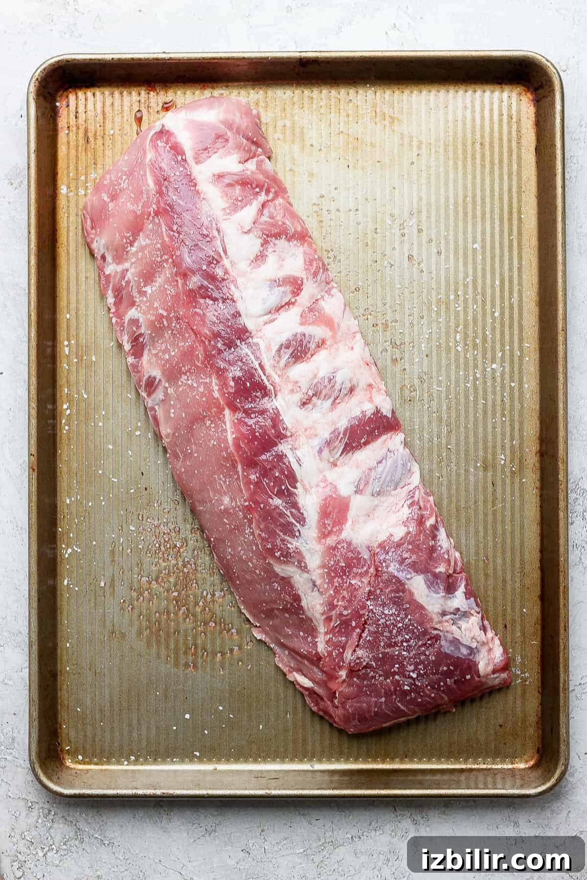 How to Make Fall-Off-the-Bone Oven Ribs 4 A slab of ribs on a baking sheet