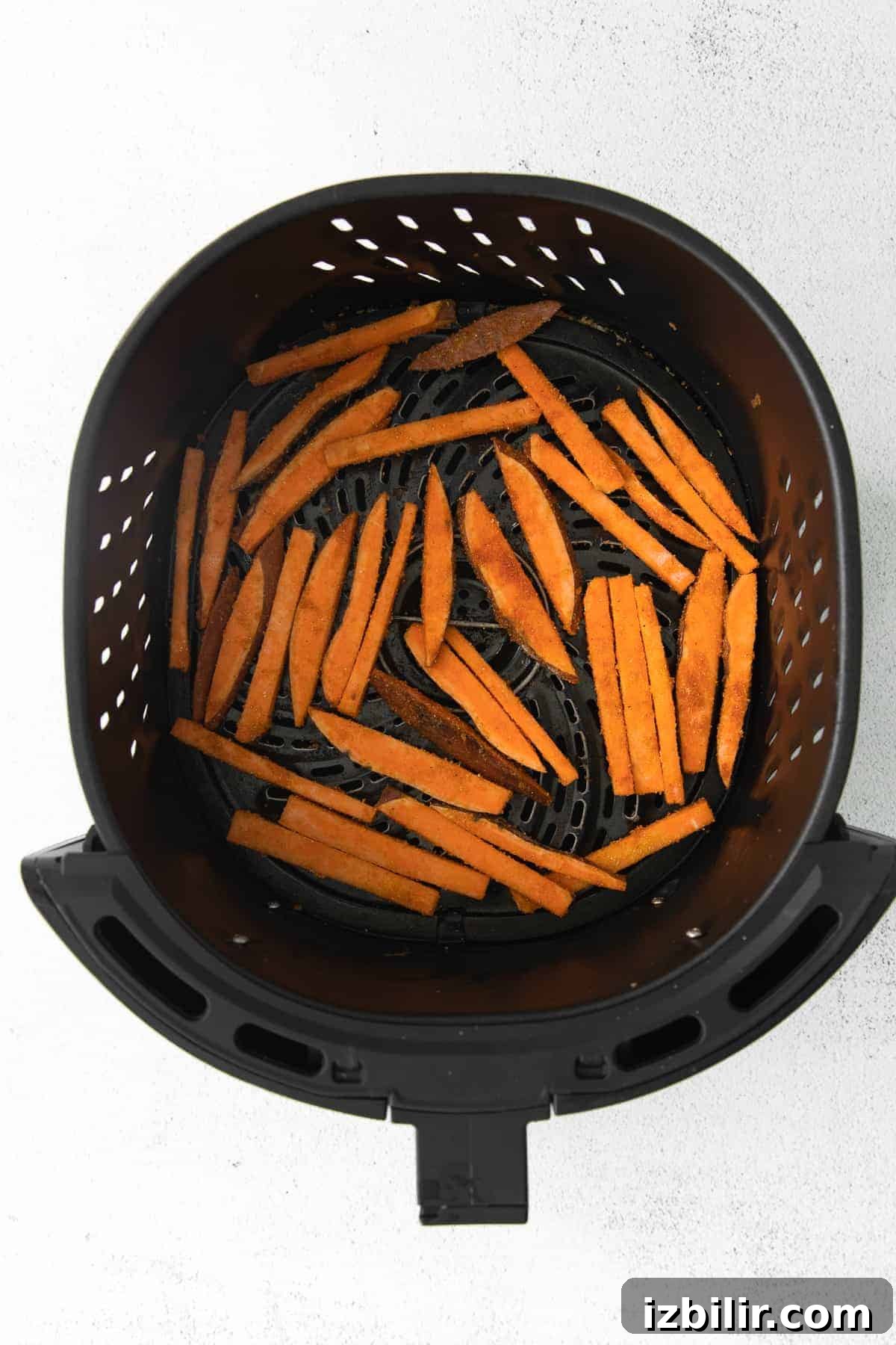 air fryer sweet potato fries in the air fryer basket
