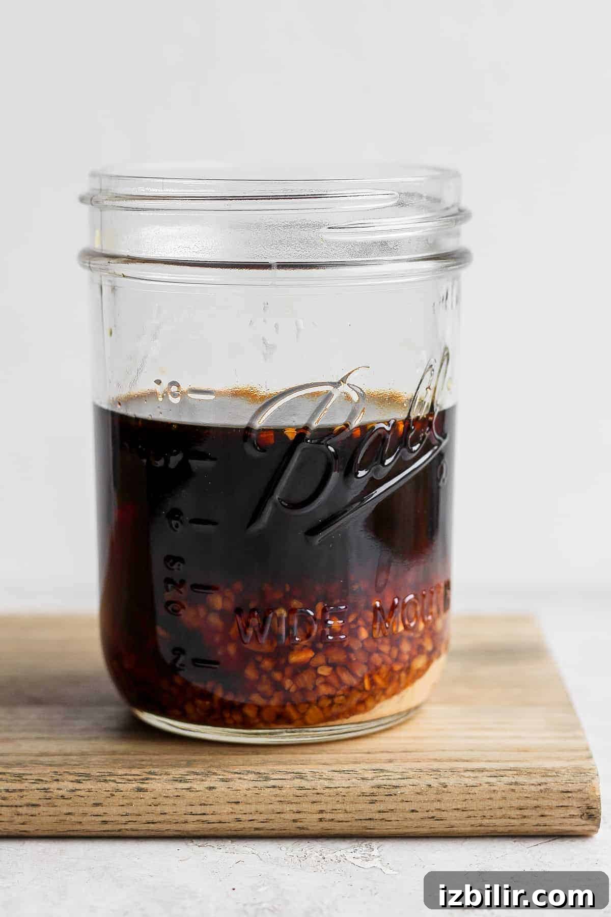 Shake the jar to combine stir fry sauce in a mason jar before being shaken to be mixed together