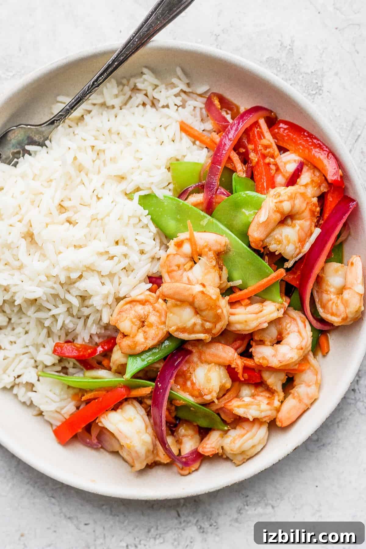 Shrimp stir fry served with white rice white rice and stir fry