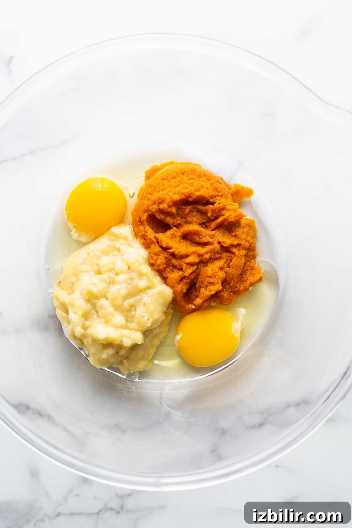 Brown Sugar Swirl Pumpkin Breakfast Cake Recipe 3 Two eggs and mashed sweet potato in a bowl.