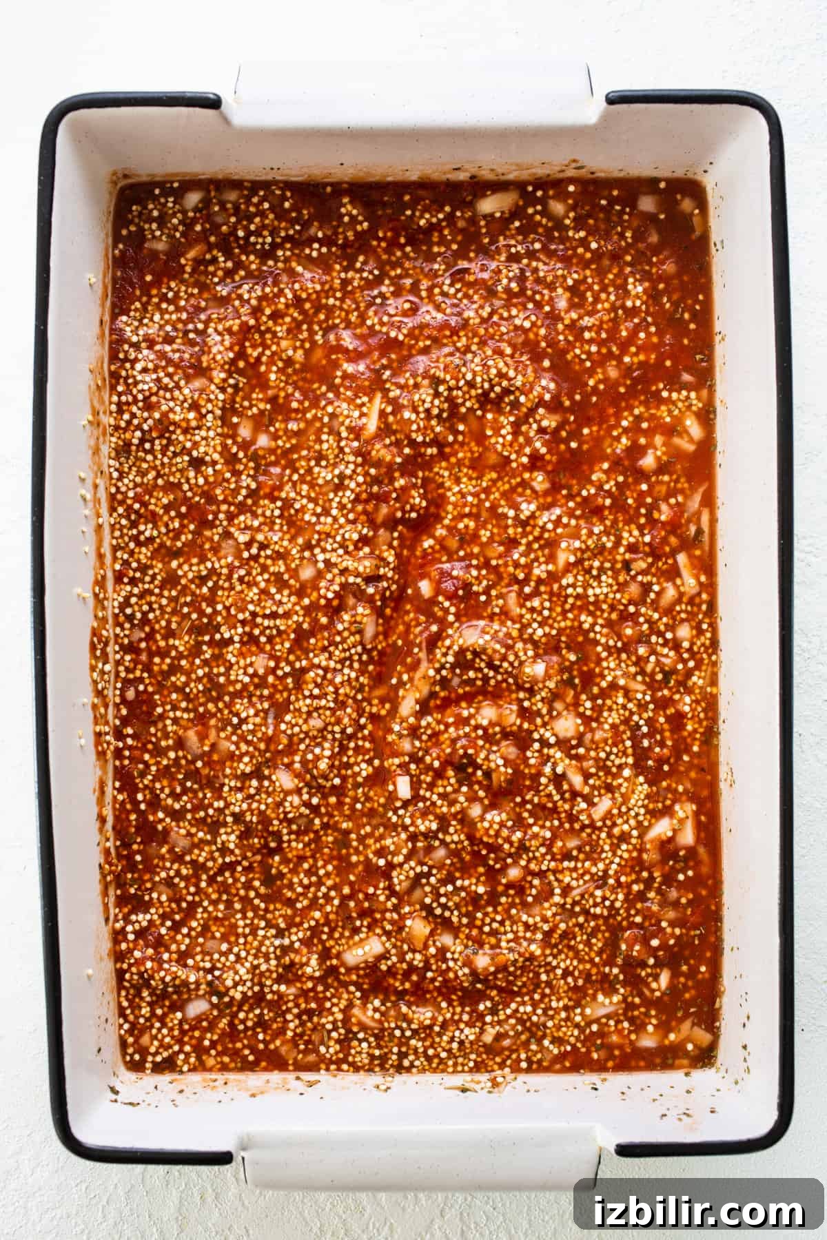 A baking dish filled with sauce and spices.