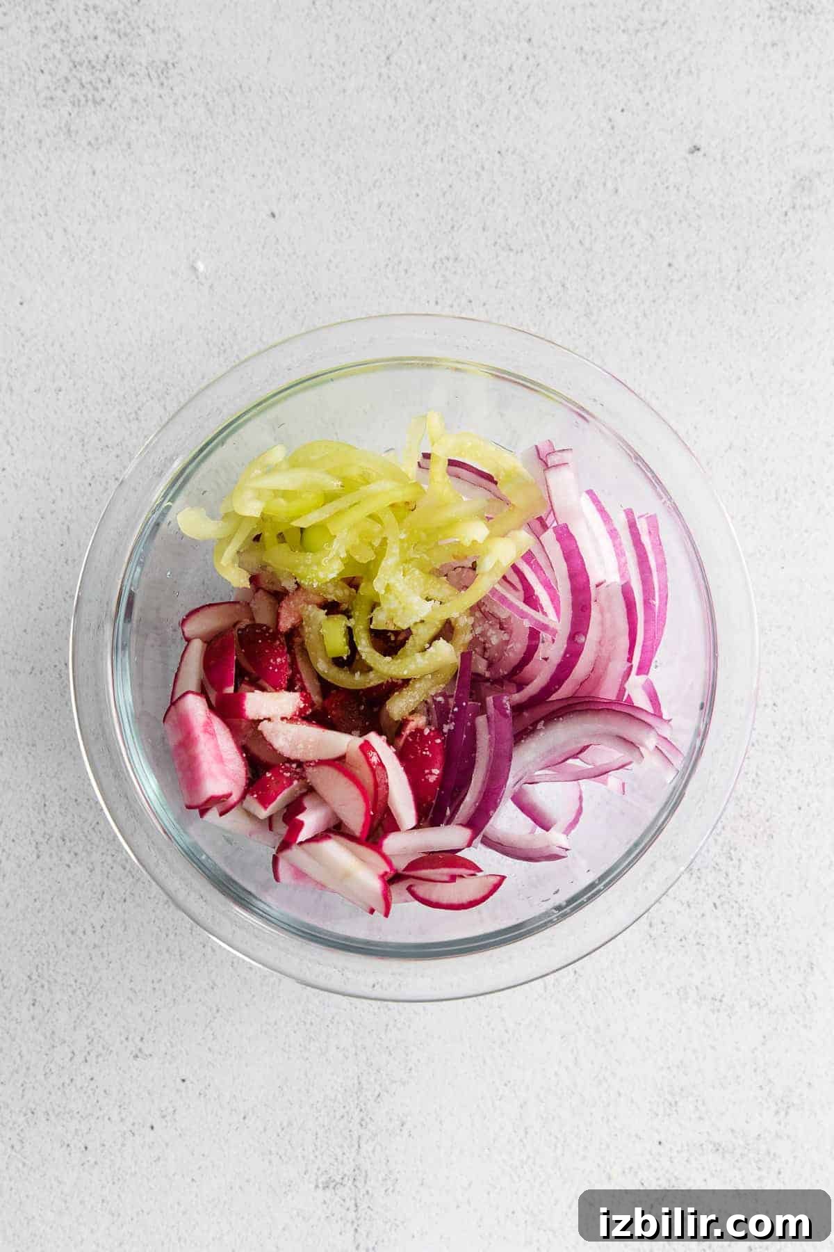 A radish slaw with banana peppers, red onion, and radishes.
