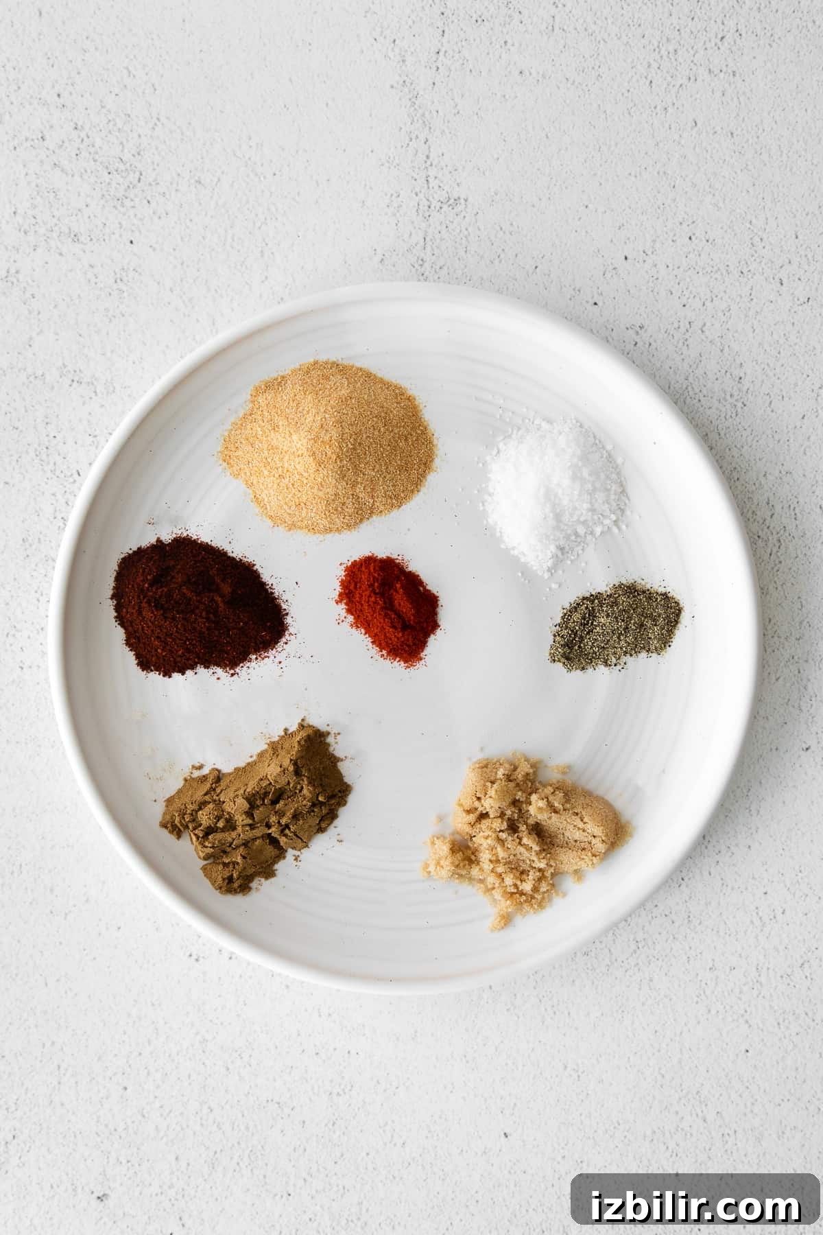 This super flavorful steak taco seasoning comes together in just 7 ingredients you likely have on hand in your spice cupboard already. ingredients for steak taco seasoning on a plate
