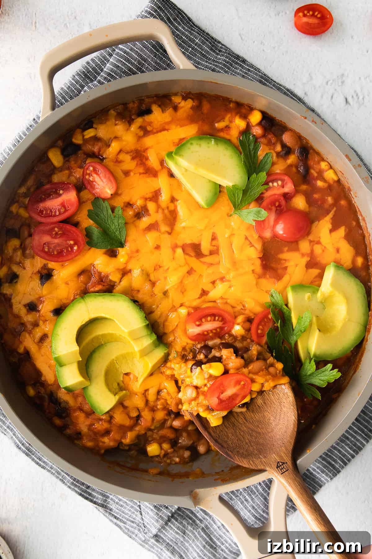 This one-pan cauliflower taco skillet uses riced cauliflower in place of white or brown rice and is made with tons of veggies, beans, and taco fixing. taco skillet in pan
