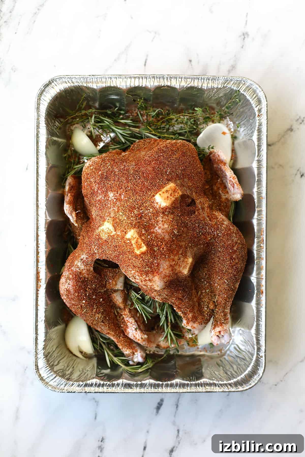 Seasoning smoked turkey in a turkey container.