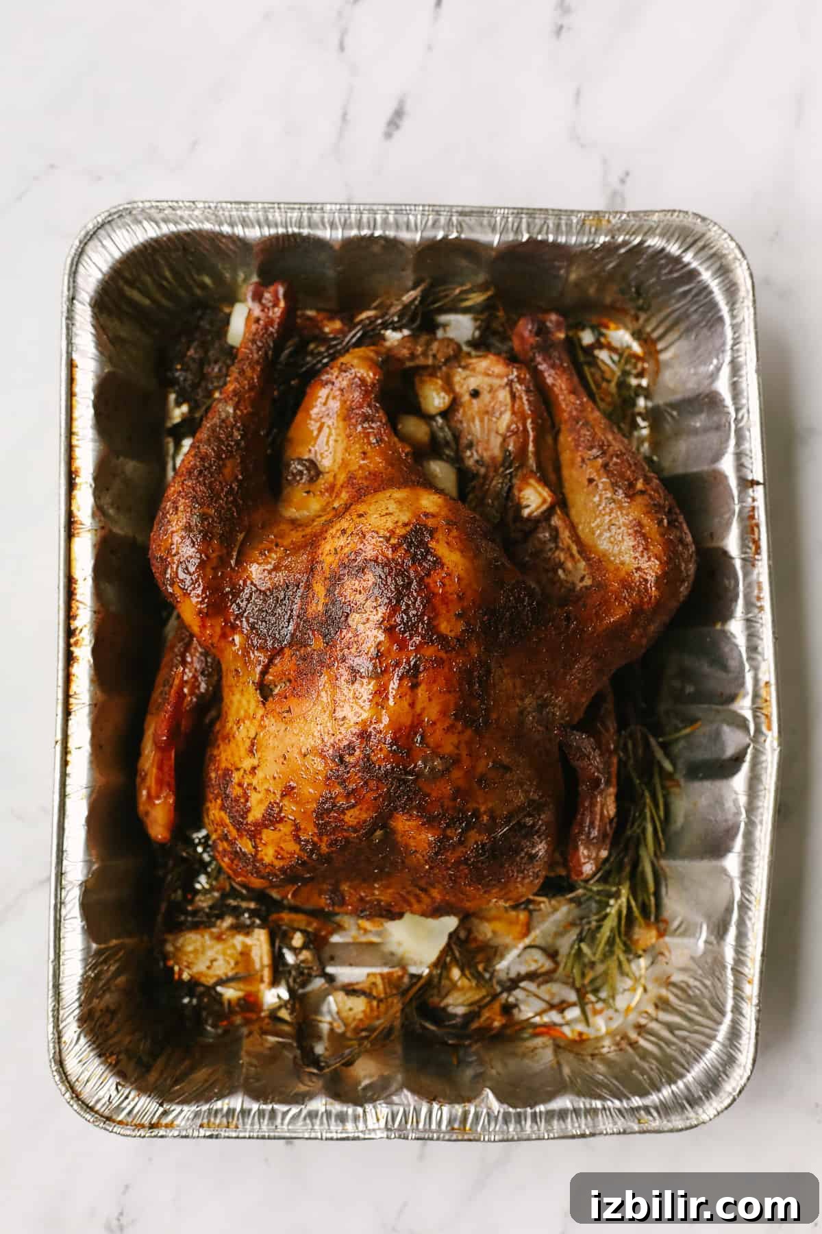 Smoked turkey in a tray.