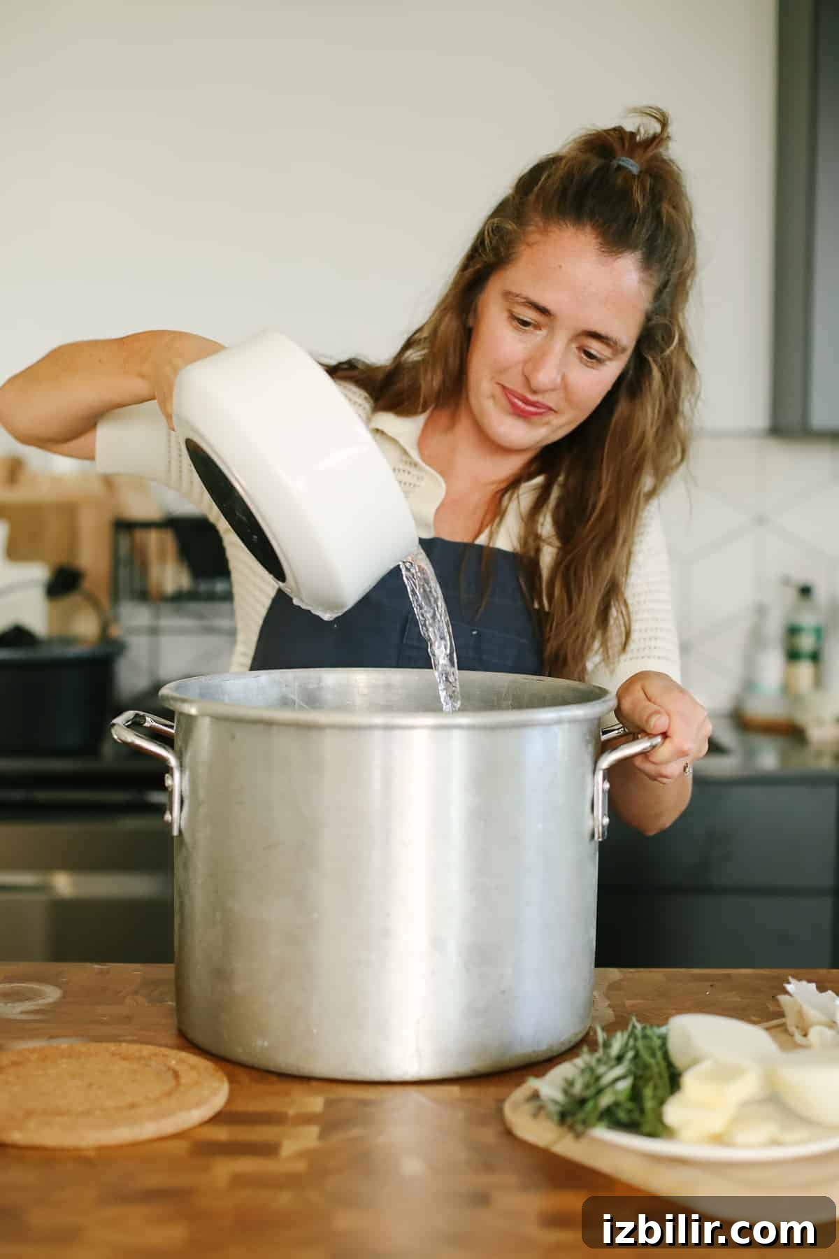 Pouring water into a huge pot.