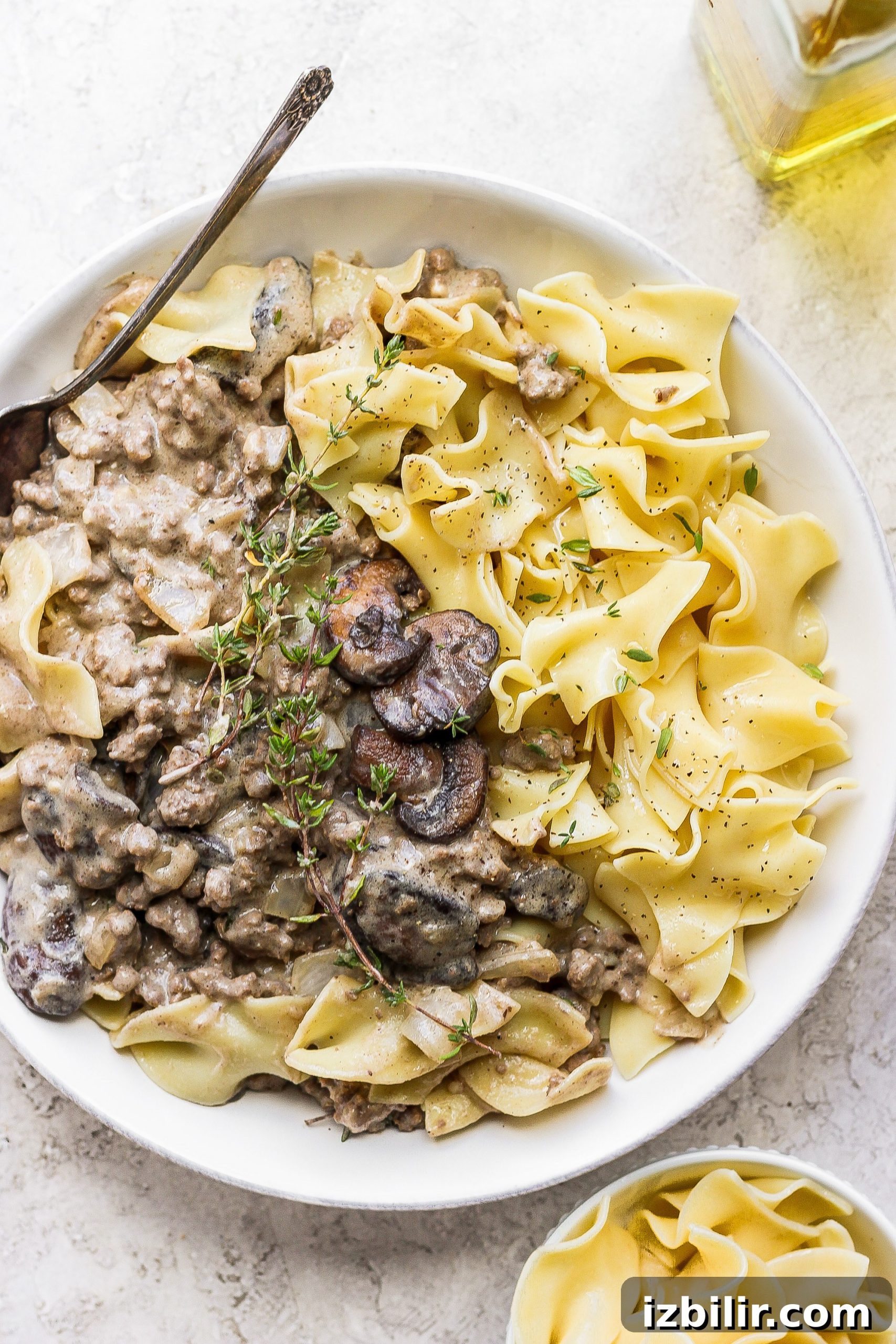 Bowl of ground beef stroganoff ground beef stroganoff in a bowl topped with fresh thyme
