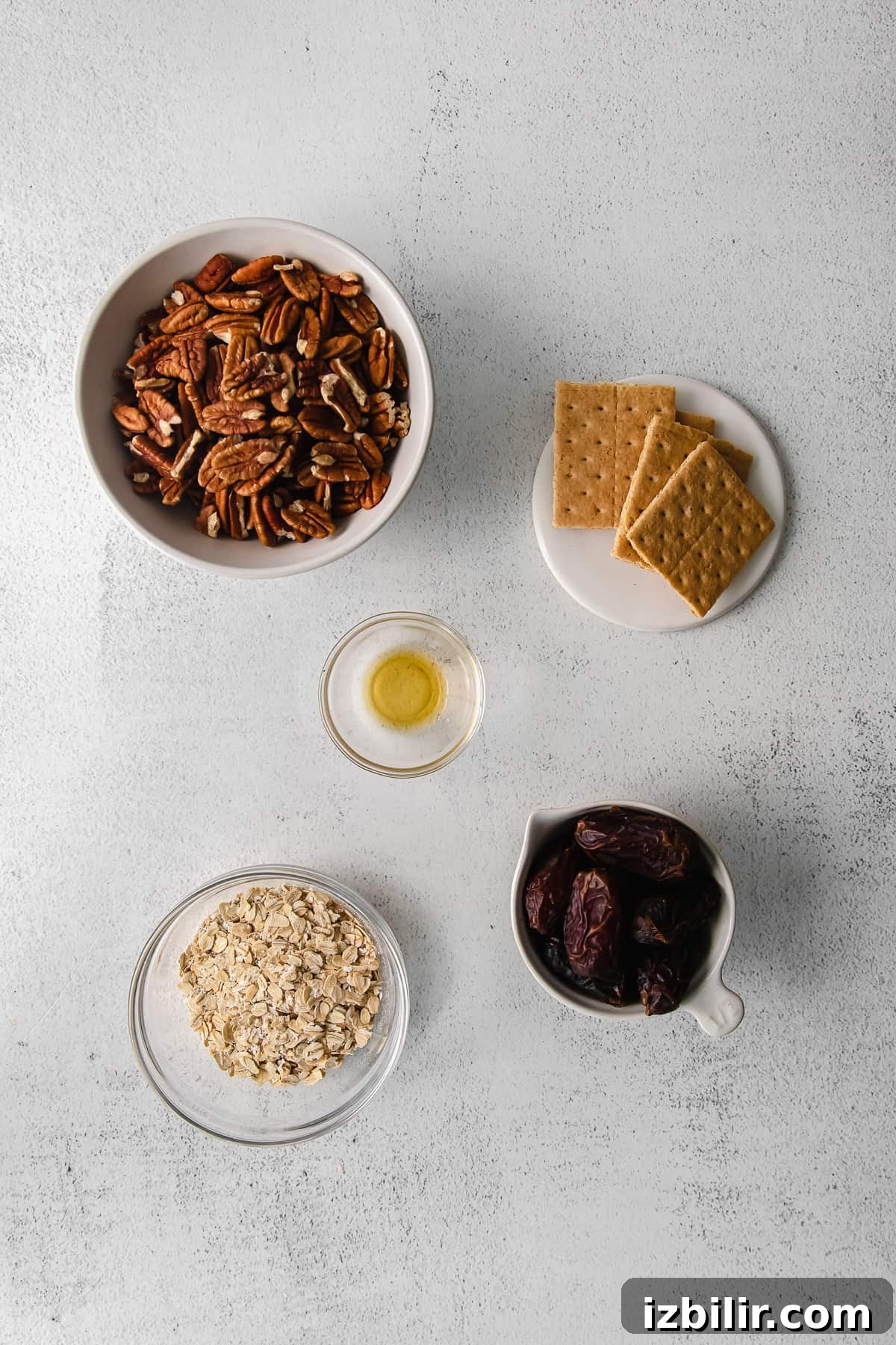No-Bake Pecan Pie Energy Balls Recipe 3 Pecans, graham crackers, vanilla extract, dates and oats in a bowl.