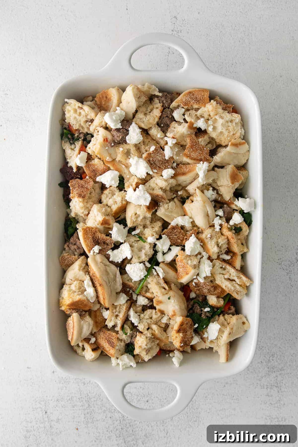 Make-Ahead English Muffin Breakfast Casserole 5 Breakfast bake ingredients in a casserole dish.