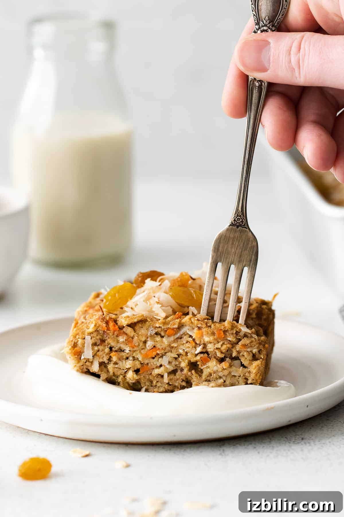 Morning Glory Baked Oatmeal slice of morning glory baked oatmeal topped with flaked coconut