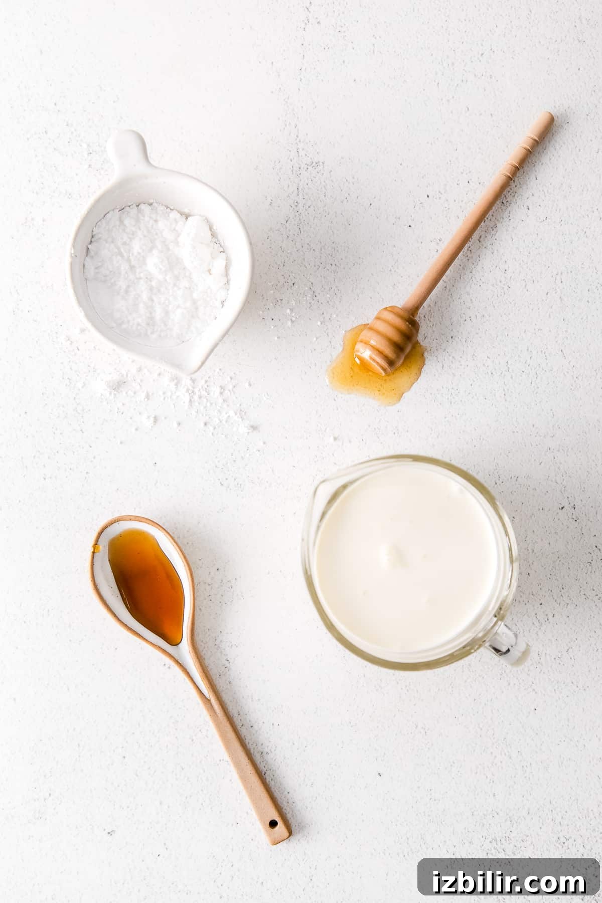 Ingredients for homemade whipped cream in small bowls.