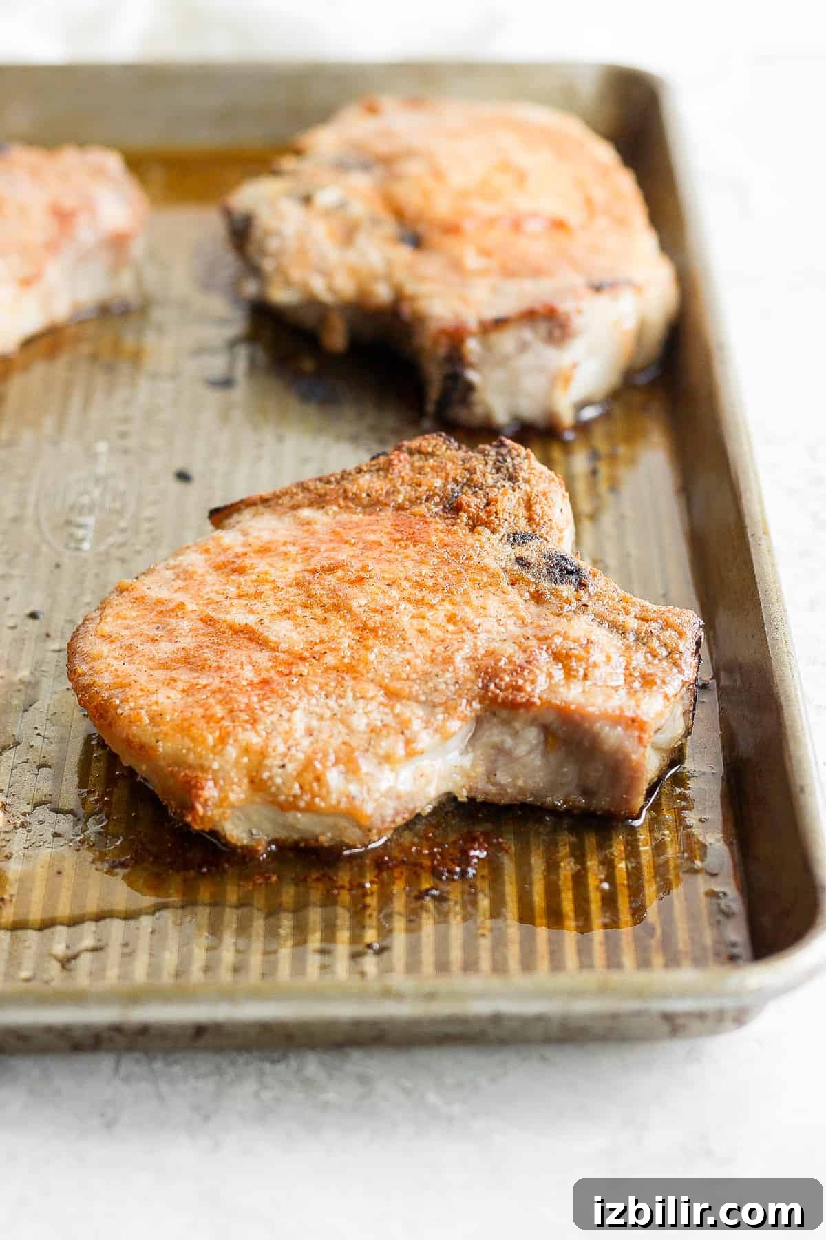 juicy oven baked pork chop on baking sheet