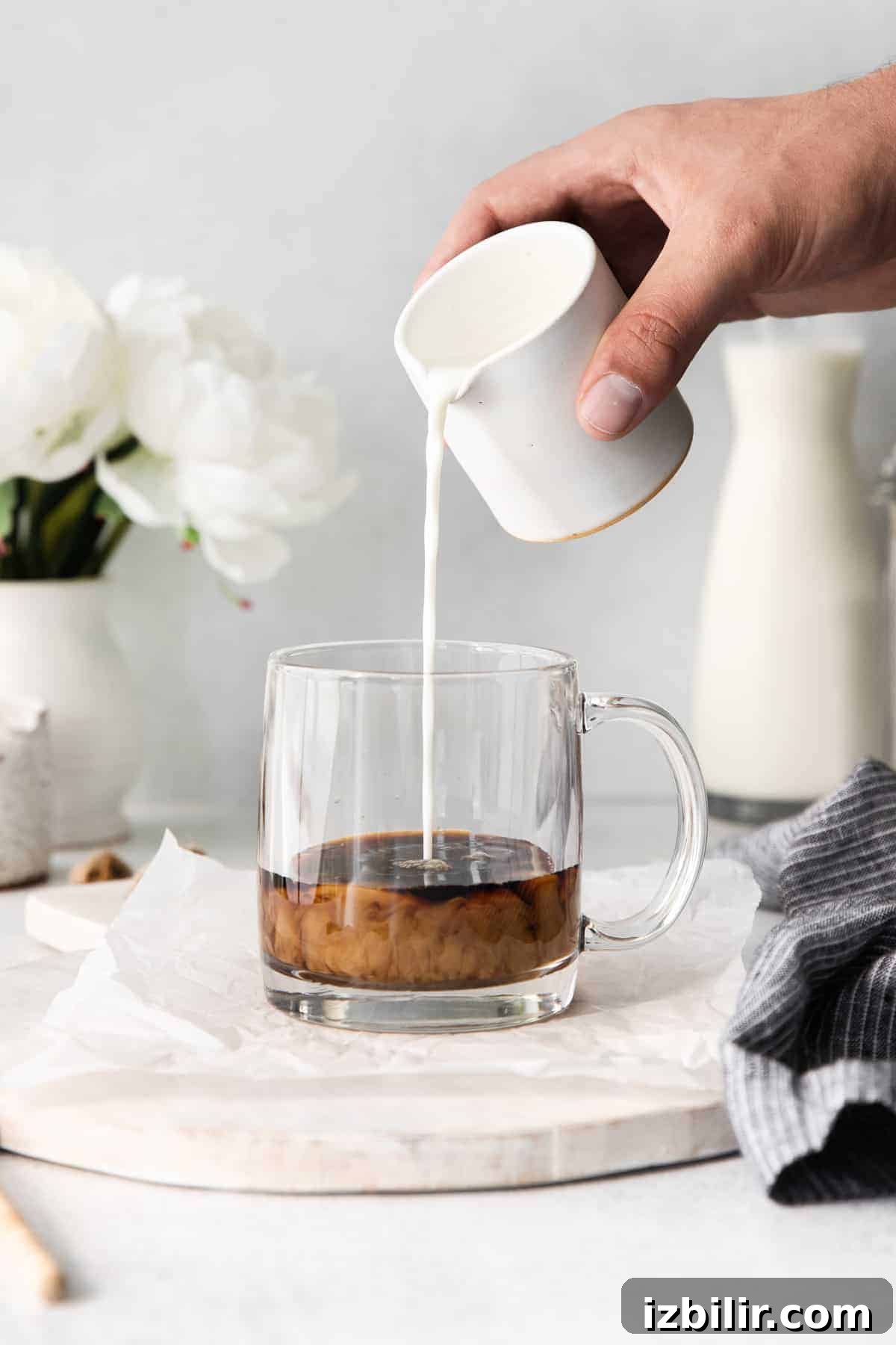 Milk poured into espresso milk being poured into espresso